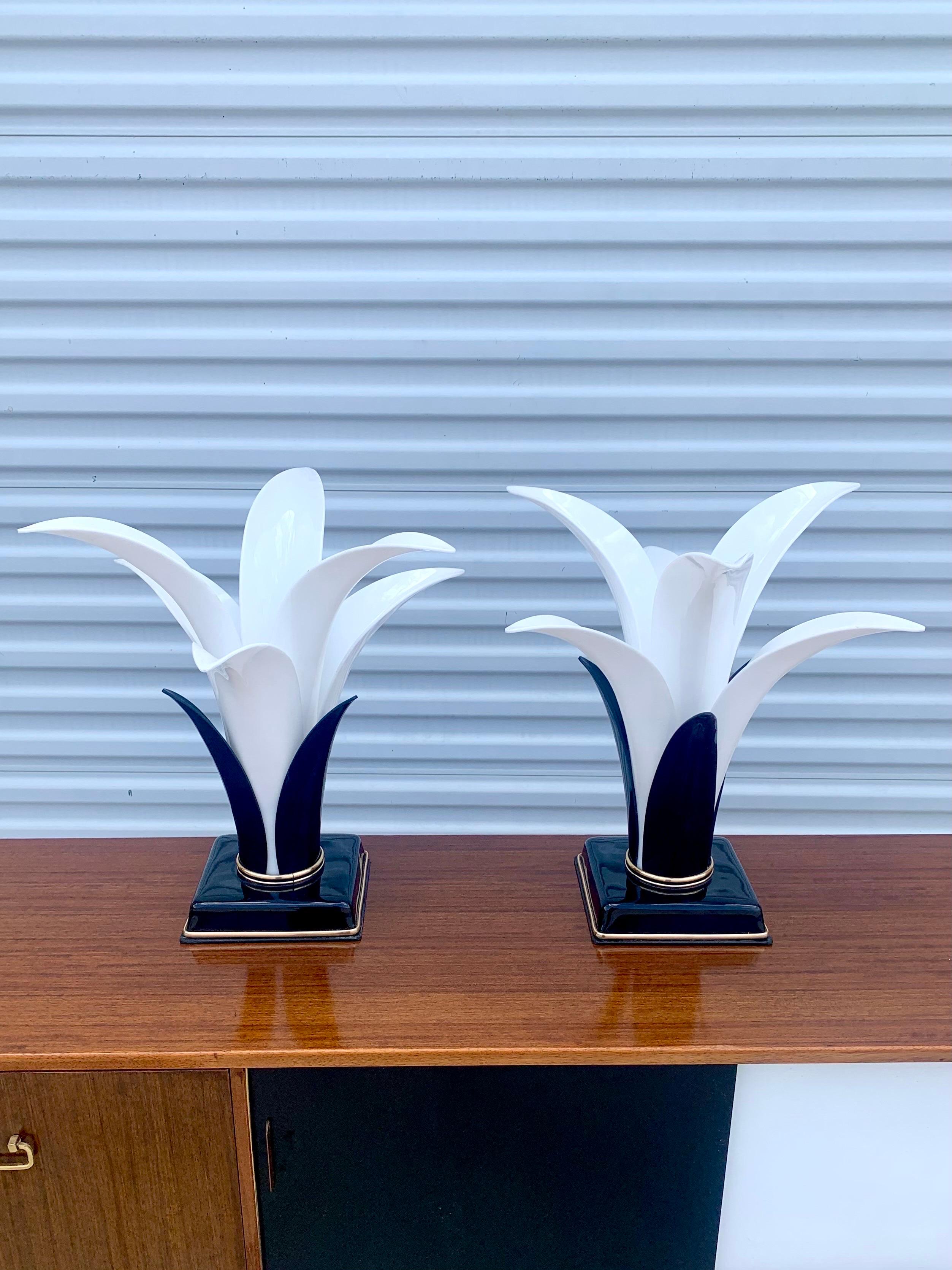 Pair of lamps made by Acrylic Designs in Miami. Beautiful and striking form made from white and black lucite pieces. Very fun and festive lamps begging to lift the spirits of any room. 

Measures: Base of the lamps are 7.5” by 7.5”

The lamps