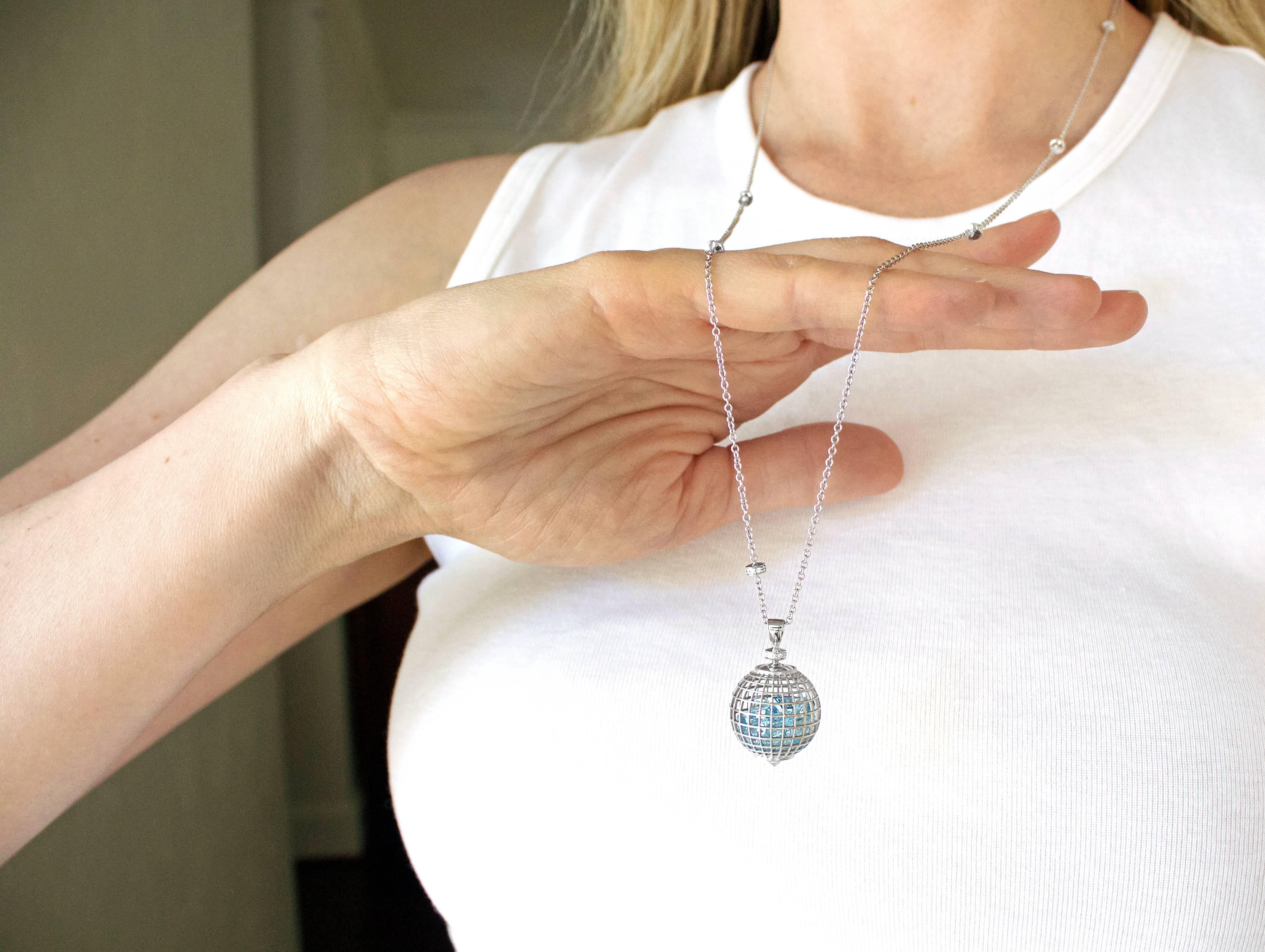 Long Shaker Globe Pendant Necklace handmade in New York by jewelry artist Roule and Co. in 18k white gold with 10.67 total carats of round aquamarine gemstones freely floating inside of open wire sphere and accented with six white diamond rondels