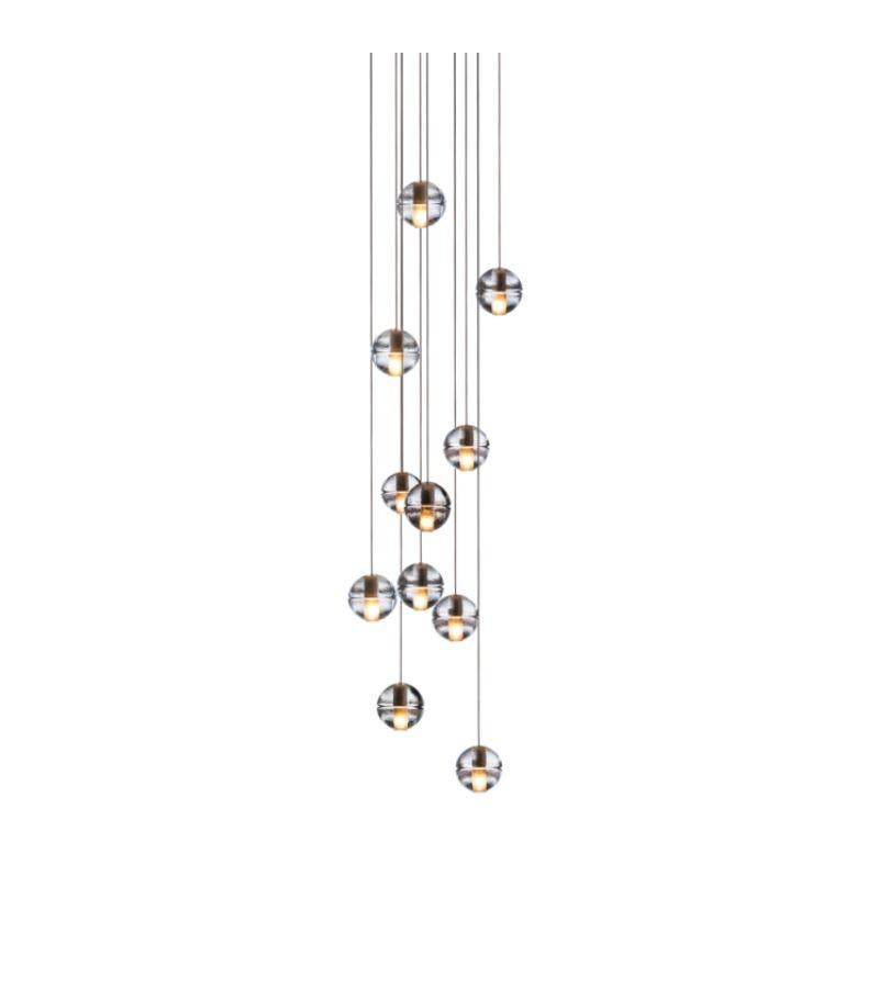 Round 14.11 chandelier lamp by Bocci
Dimensions: Diameter 60 x H 300 cm 
Materials: Brushed Nickel, Cast glass, blown borosilicate glass, braided metal coaxial cable, electrical components, white powder-coated canopy.
Available in Rectangular or