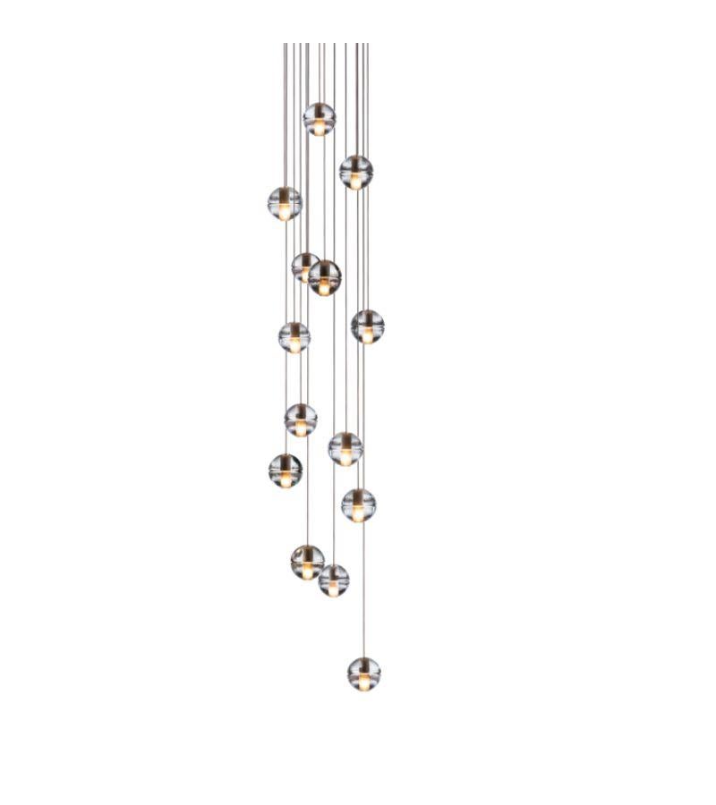 Round 14.14 chandelier Lamp by Bocci
Dimensions: diameter 50.8 x height 300 cm 
Materials: brushed nickel, cast glass, blown borosilicate glass, braided metal coaxial cable, electrical components, white powder-coated canopy.
Available in
