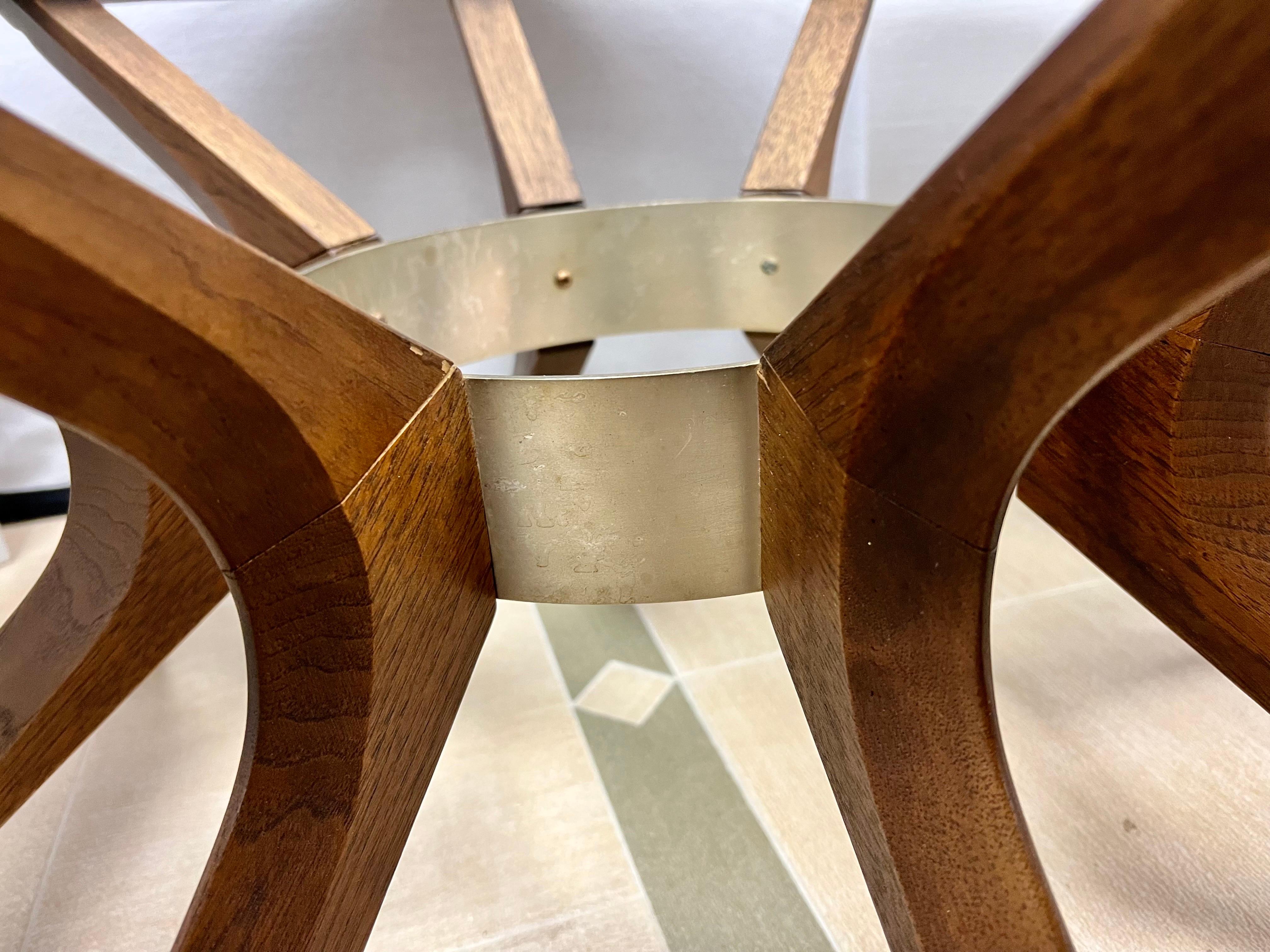 Mid-century Brasilia round walnut cathedral coffee table has a removable glass center inset over sculptural steel splayed legs. Iconic period details with wonderful scale and better lines. A signature piece for a collector or someone trying to set