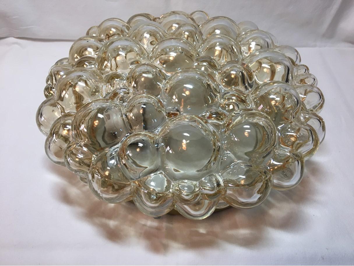 Round flush mount ceiling lamp made of honey colored bubble glass in the style of Helena Tynell, Germany, 1960s. The fixture requires two European E26 / E27 Ediso. Bulbs, each bulb up to 40 watts. Rewired to meet U.S. standards.