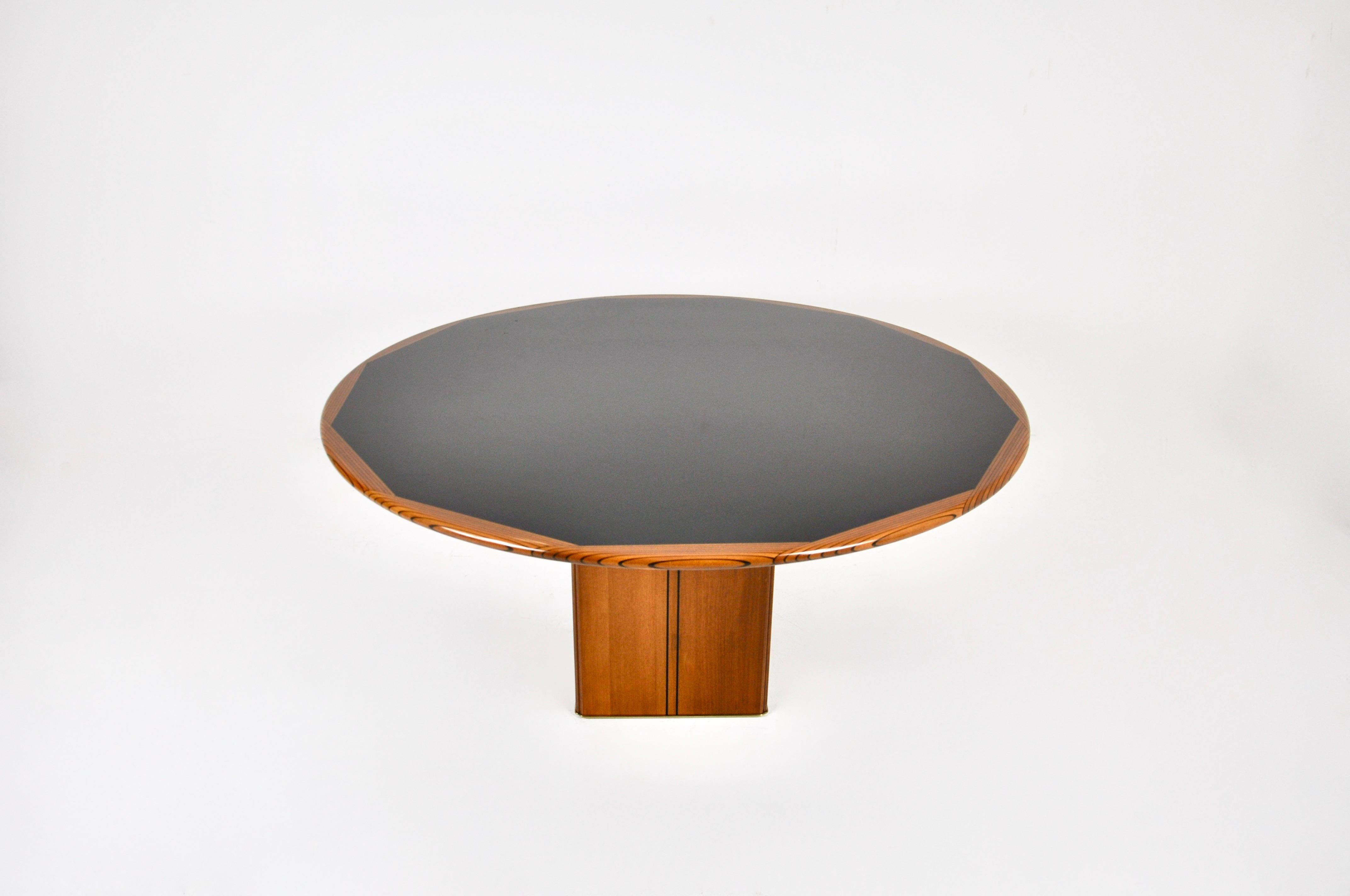 Round wooden table by Tobia and Afra Scarpa. Stamped concrete block inside the table for stability. Wear due to time and age of the table.