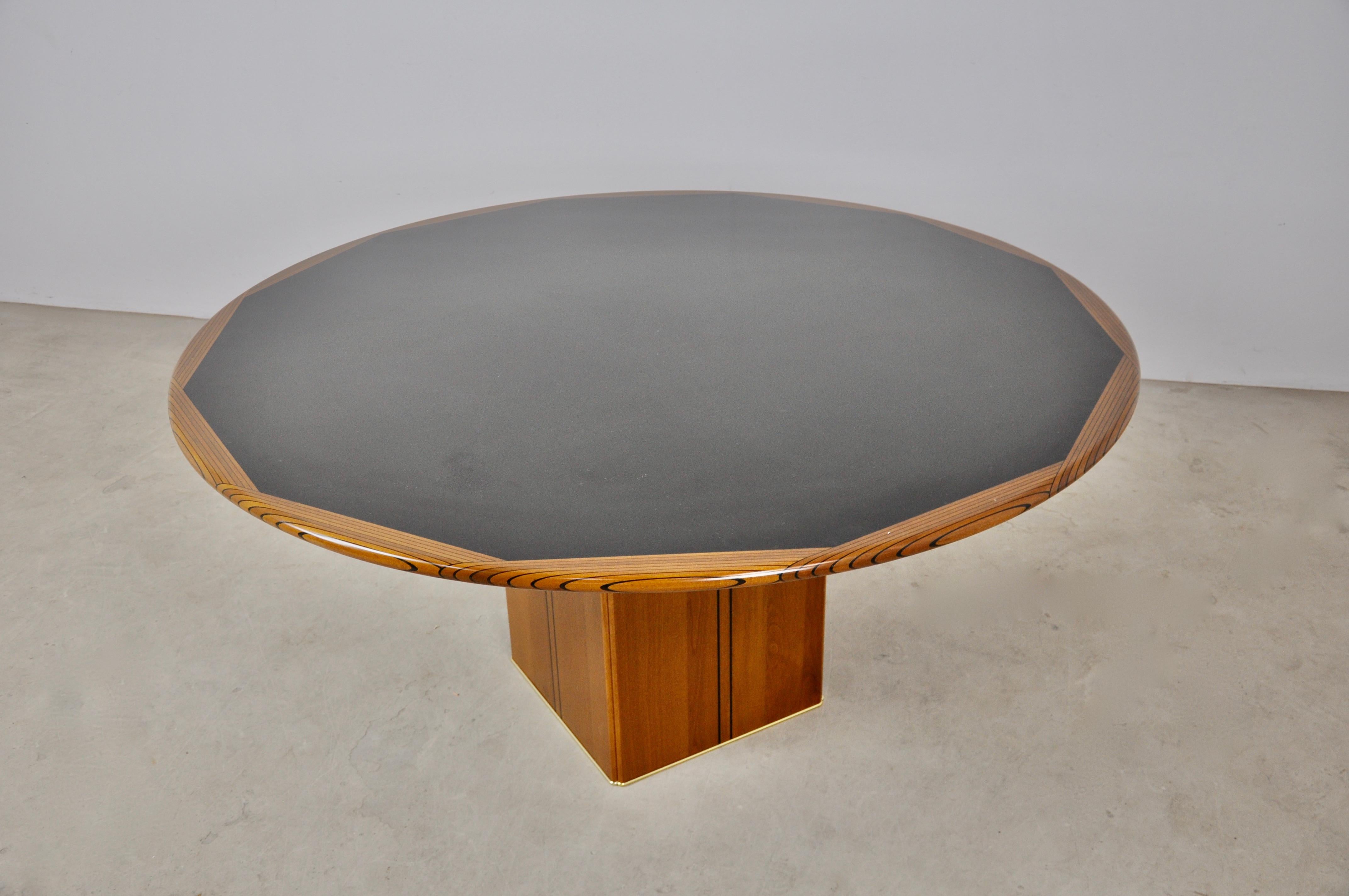 Round wooden table. By Tobia&Afra Scarpa. Concrete block inside the table for stability stamped.
