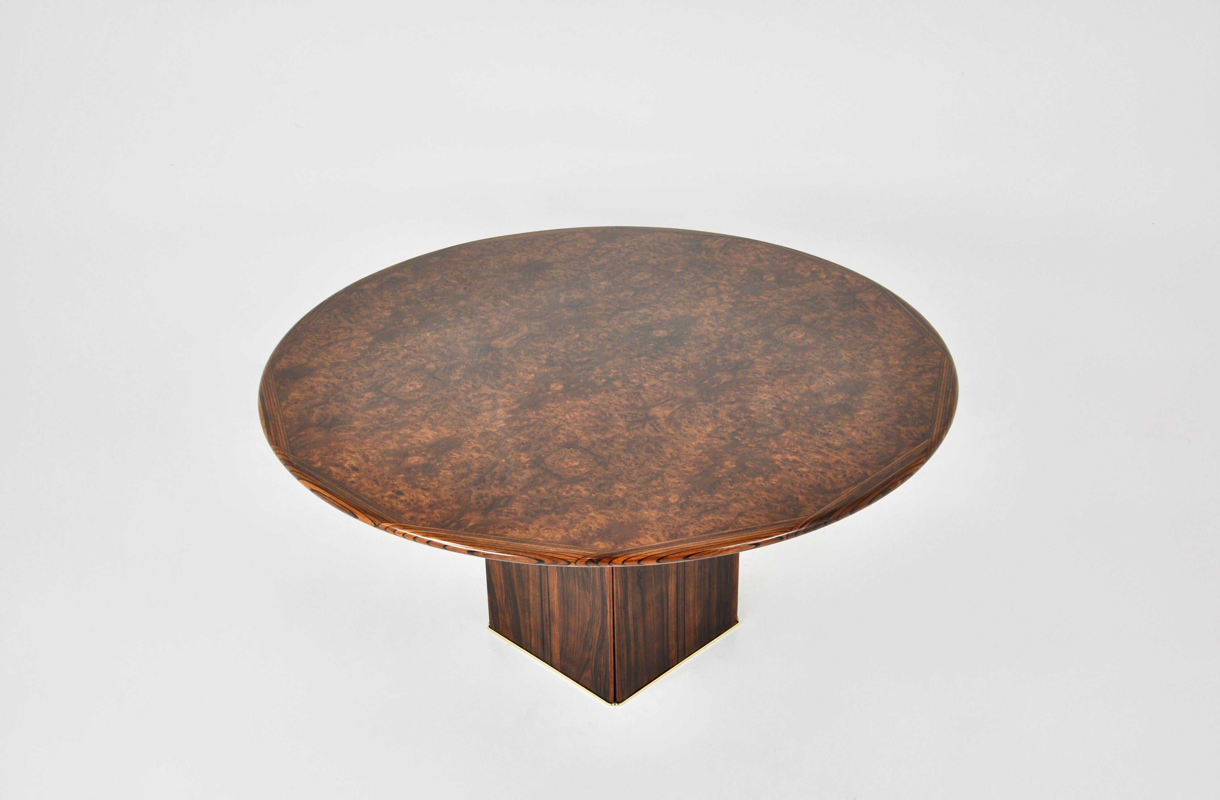 Round wooden table by Tobia and Afra Scarpa. Bottom of leg encircled in brass. Stamped concrete block inside the table for stability. Wear due to time and age of the table.