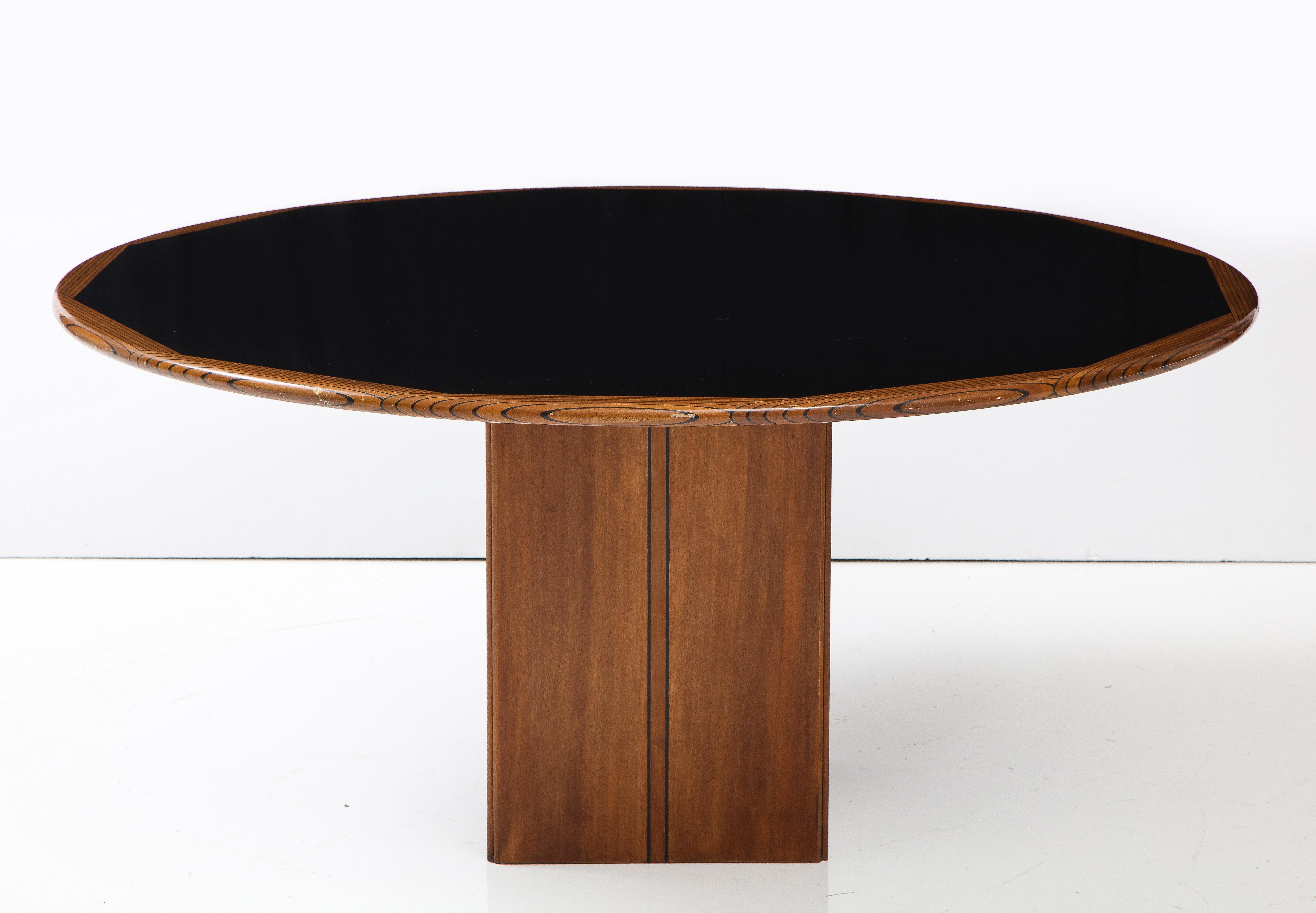 Round 'Africa' table, designed by Afra & Tobia Scarpa, for Maxalto 'Artona' Series. 
The circular top in ebony wood, with the outer rim in ebony and walnut. The whole is supported on a square pedestal base. This round dining table, which also works