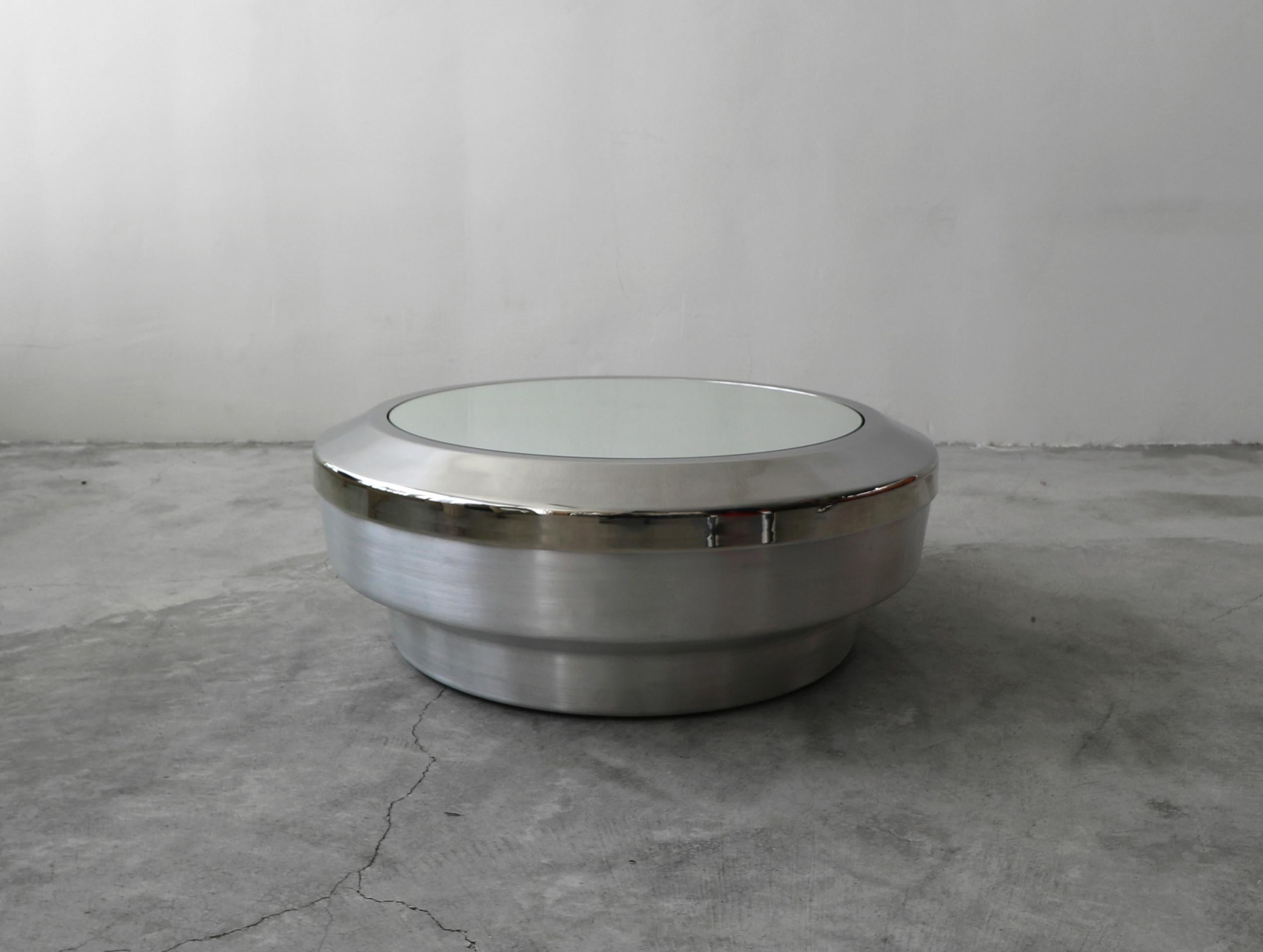 Beautiful Spun aluminum, chrome and mirror drum canister coffee table by architect Gary John Neville. Top is removable to provide a great storage space for blankets, pillows, etc.

Table is in excellent condition with no real damage to be noted.