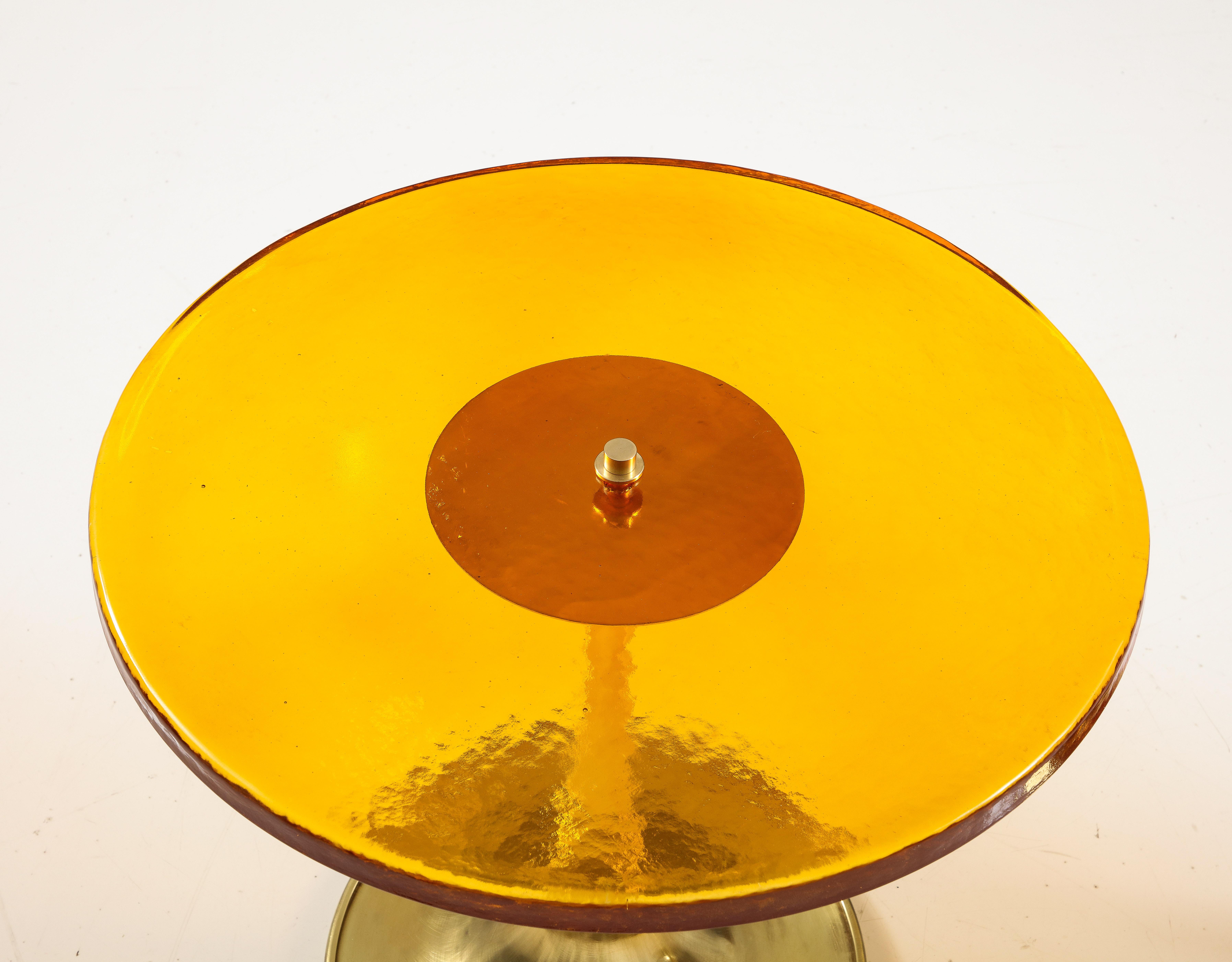 Round Amber or Deep Gold Murano Glass and Brass Martini or Side Table, Italy, 2023. Hand-casted 1 inch thick, solid, amber or deep gold (almost orange) colored Murano round glass top sits atop a hand-turned, trumpet-shaped brass base. A modern flat