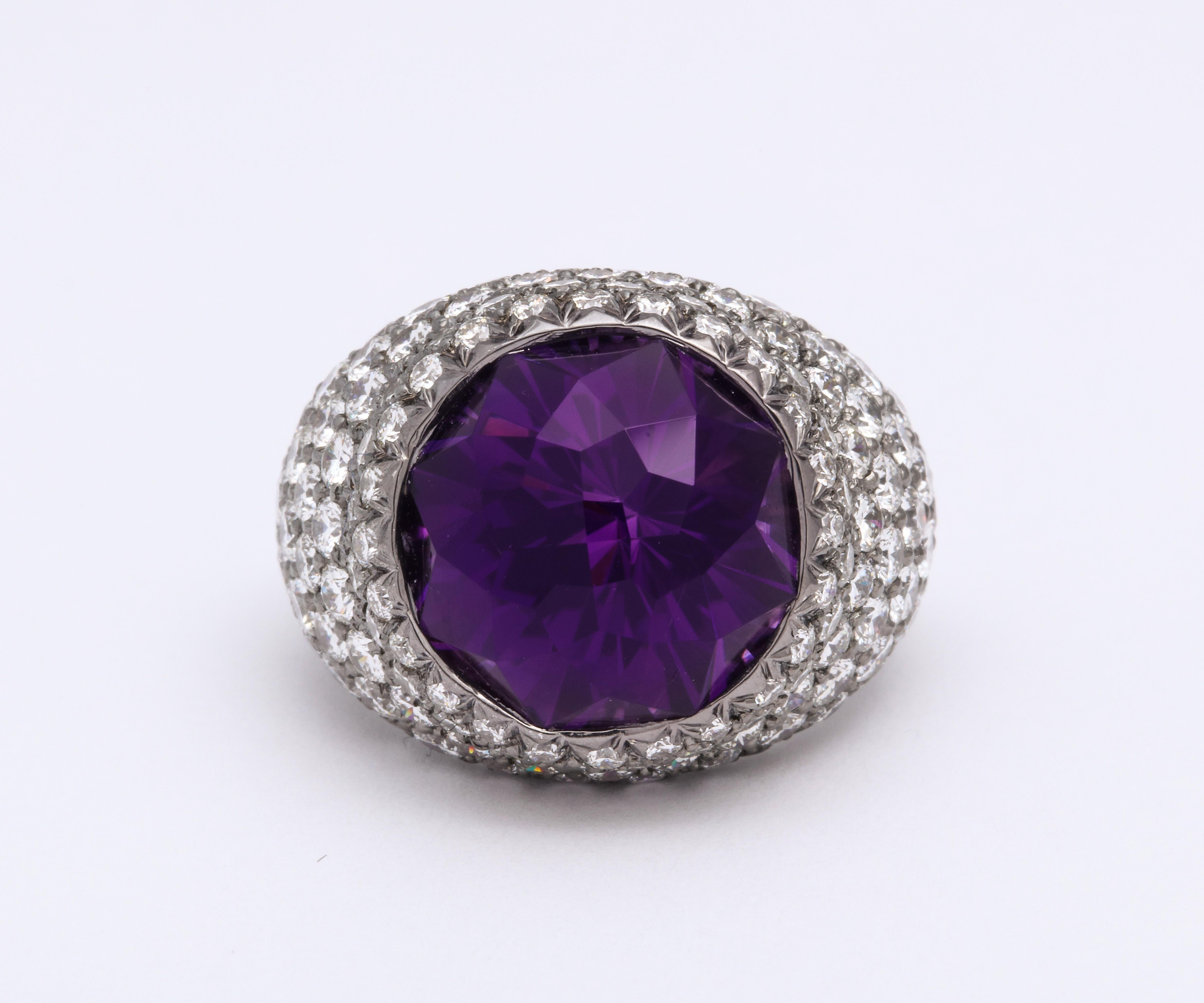 Make an '80s statement with this masterful piece of craftsmanship.  A cocktail ring featuring a round rose cut amethyst by famed lapidary Phillip Youngman, weighing 10.53 carats. 137 round brilliant diamonds, pavé -et weighing 4.30 carats total. Set