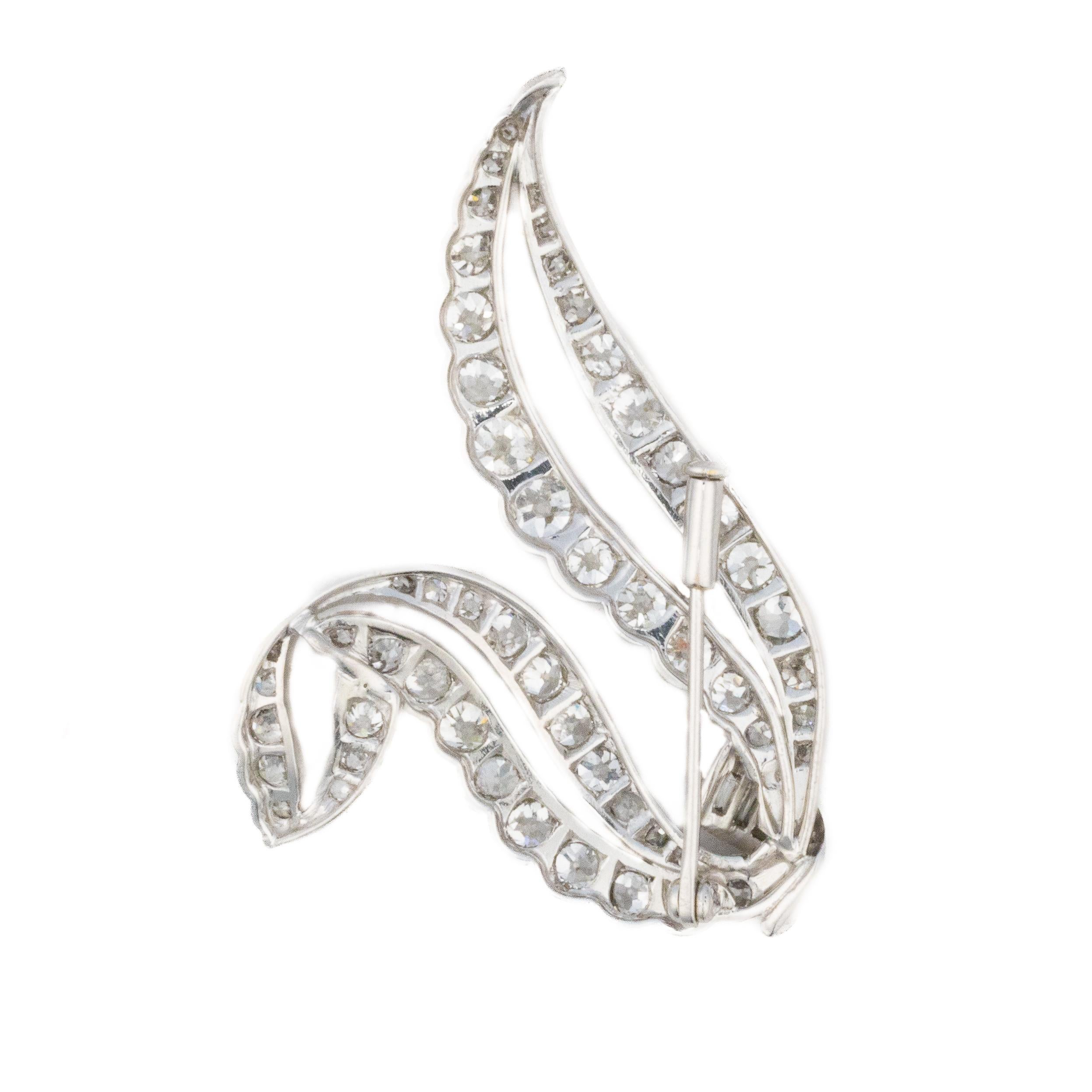 Round and Baguette Diamond Ribbon Brooch in Platinum

Evoking the elegance of a flowing ribbon, this mid-century brooch is a striking composition of brilliant and baguette-cut diamonds set in platinum. The sculptural curves are lined with vibrant