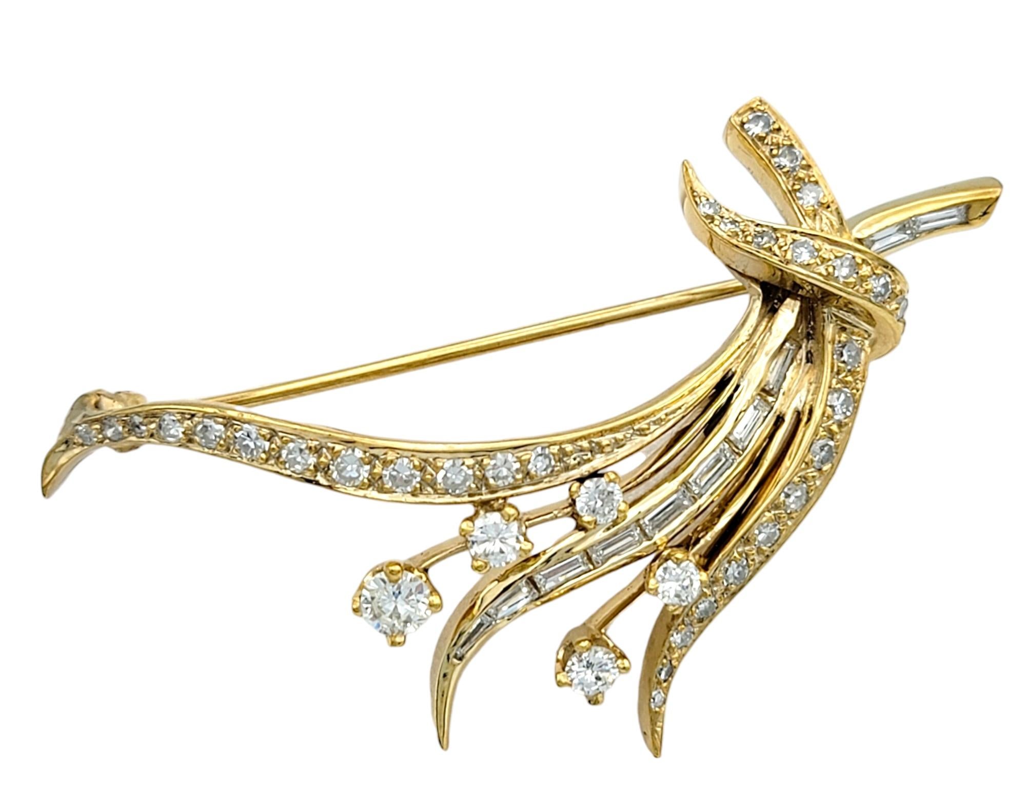 Radiate timeless elegance with this exquisite round and baguette diamond spray brooch, a captivating piece crafted in luxurious 14 karat yellow gold. This brooch boasts a dynamic, nature inspired spray design, where shimmering diamonds form delicate
