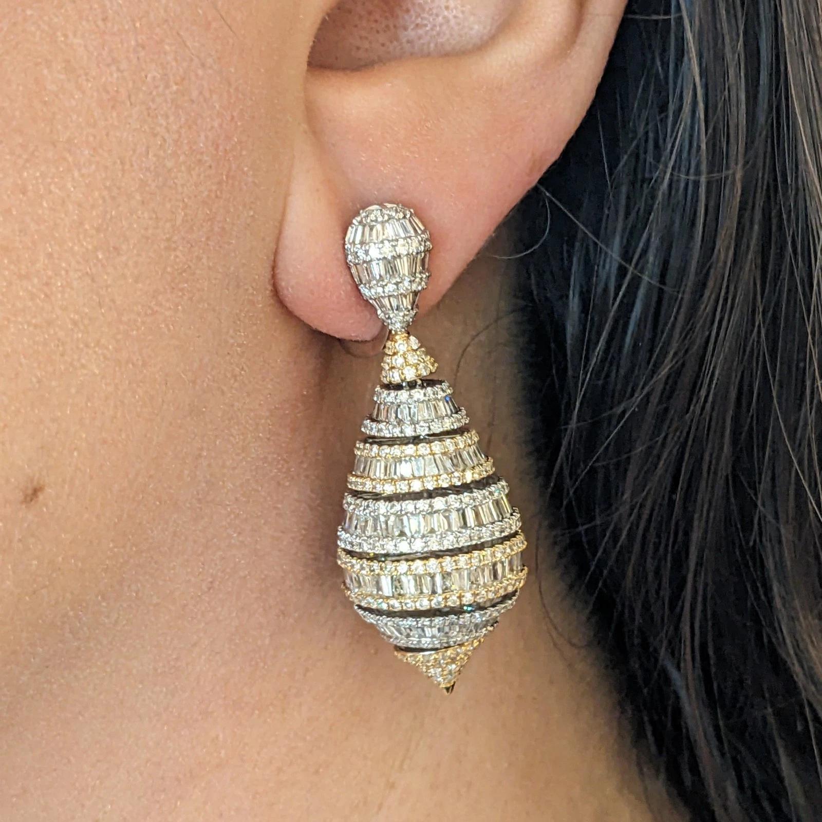 Orecchini a goccia con diamanti rotondi e baguette 11,00 cttw in oro 18k

Gli orecchini a goccia con diamanti presentano file di diamanti rotondi e baguette incastonati in oro bianco e giallo 18 carati che formano una forma a goccia con diamanti che