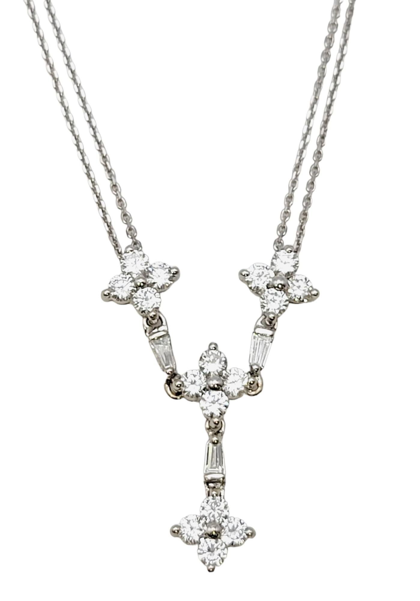 This delicate double chain diamond drop necklace is absolutely stunning. Featuring round and baguette shaped glittering natural diamonds and solid 14 karat white gold, this stunning piece offers femineity and elegance in a timeless style. The double