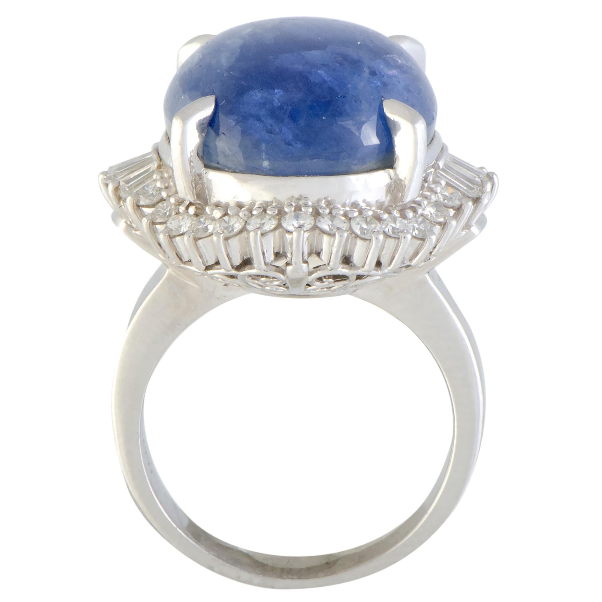 The compelling star sapphire takes the central place in this spectacular ring in a most imposing fashion, lending its spellbinding allure to the piece. The ring is expertly crafted from prestigious platinum and it is also set with diamonds that