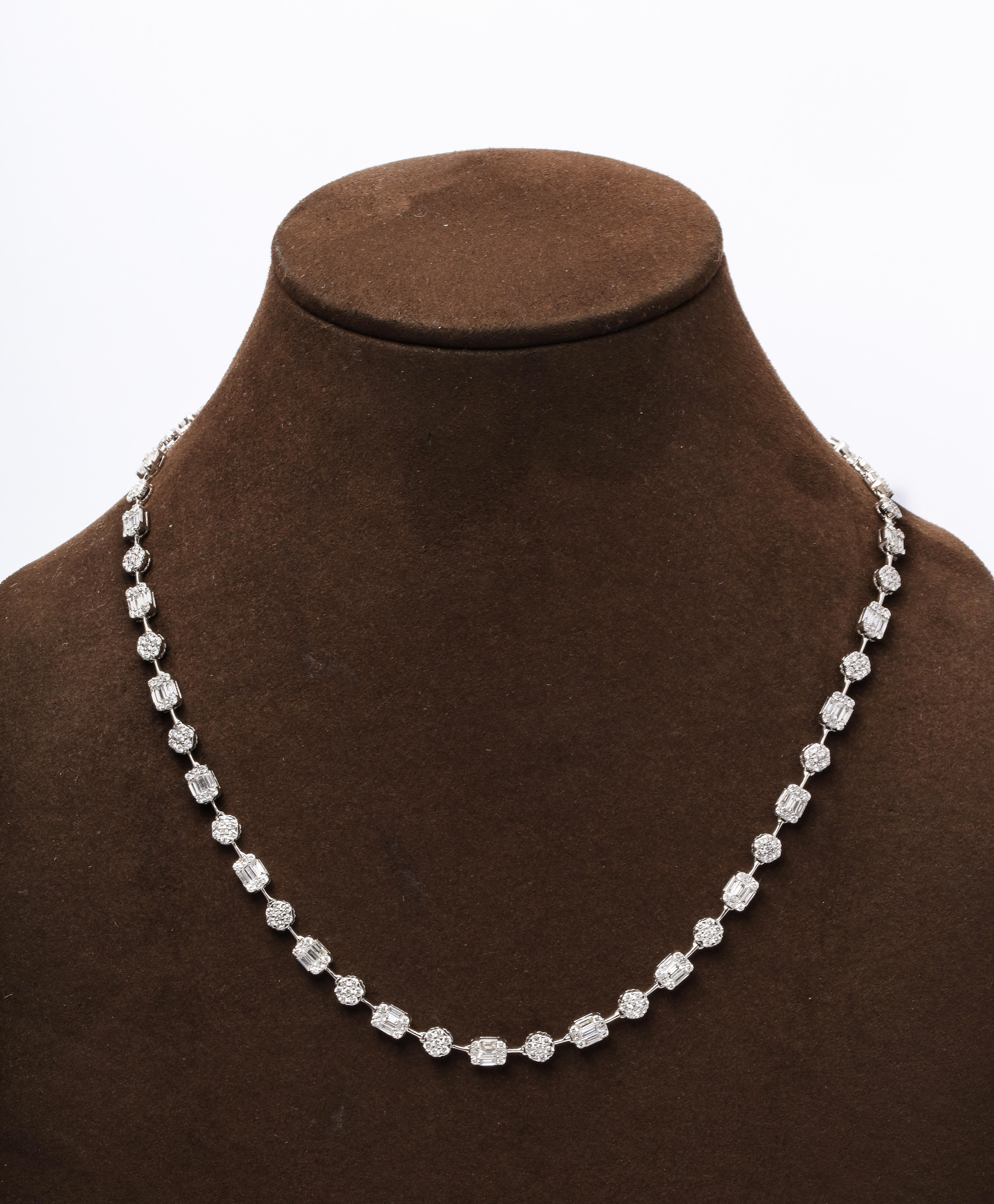 
An stunning multi shape diamond illusion set necklace.

7.74 carats of white round and baguette diamonds set in 18k white gold 

17.25 inch length that can be adjusted