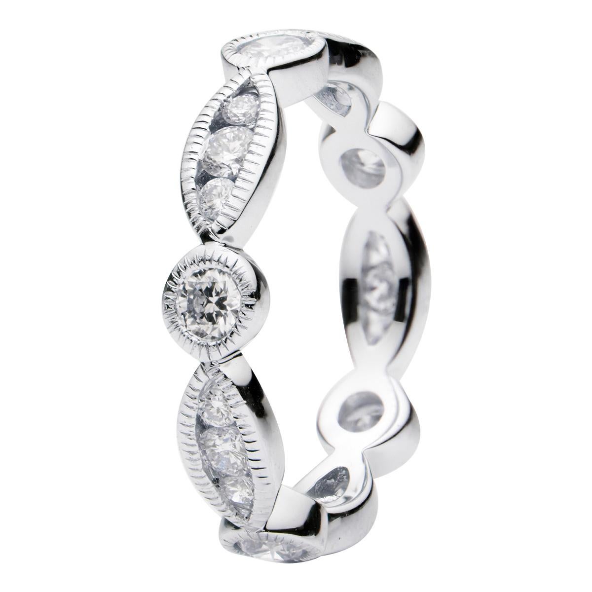 This stunning eternity band goes all the way around the finger alternating between round diamonds and 3 smaller diamonds that make up the look of a marquee diamond. The 20 round diamonds are VS2, G color and total 0.90 carats. This ring is made from