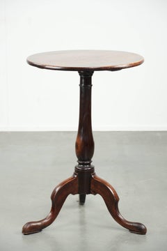 Round antique side/wine table from the late 18th century with a subtle foot