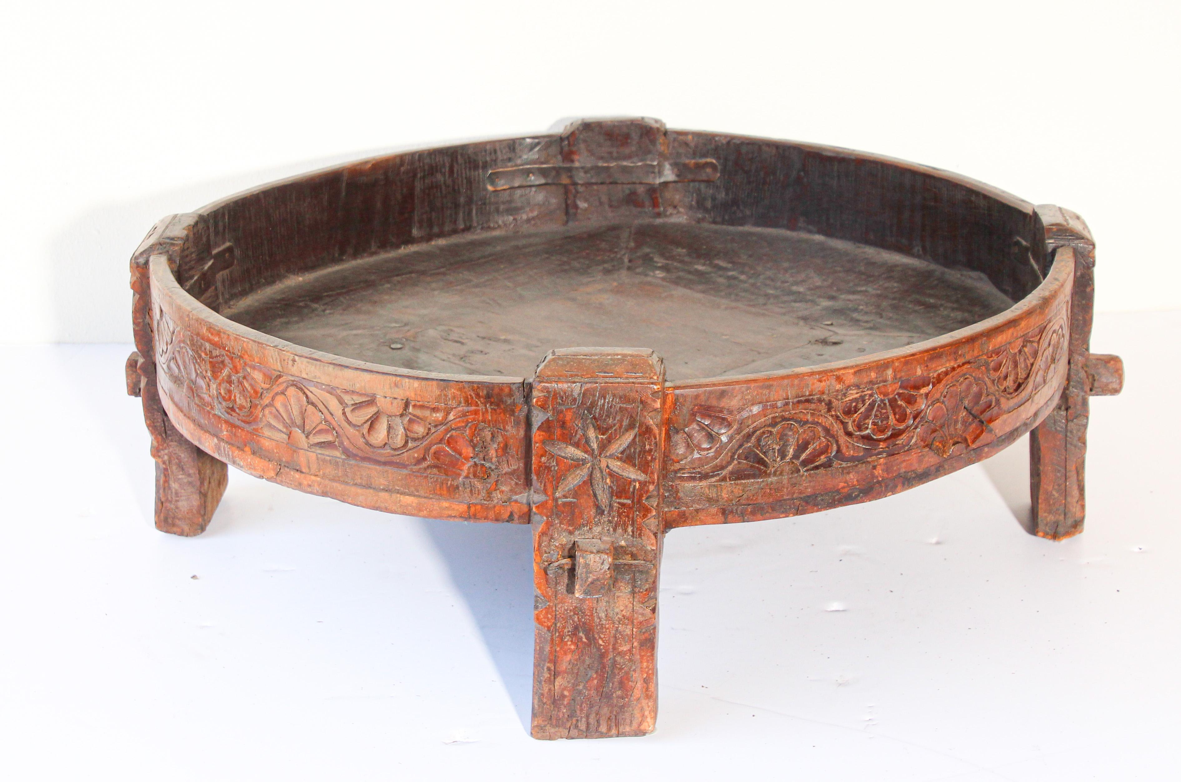 Large antique hand carved wood Indian grinder tribal teak table.
Walnut color hand carved with geometric tribal design.
Handcrafted of wood and iron, hand carved with geometric ethnic tribal design.
Very sturdy rustic wood table with nice patina,
