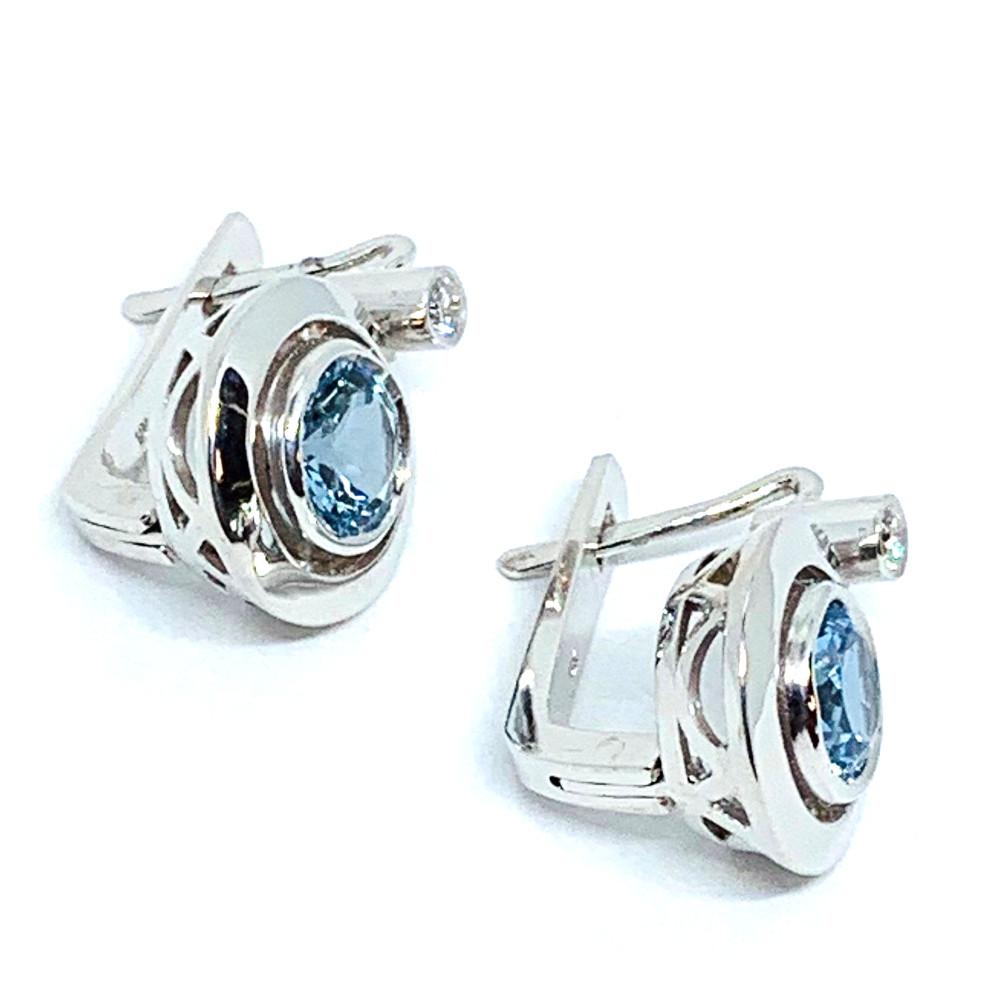 These pretty 18k white gold drop earrings feature beautifully crystalline, sky-blue aquamarines in a simple, yet chic and sophisticated design! Two sparkling gems are set in bright white gold bezels, then set in a second halo for an elegant