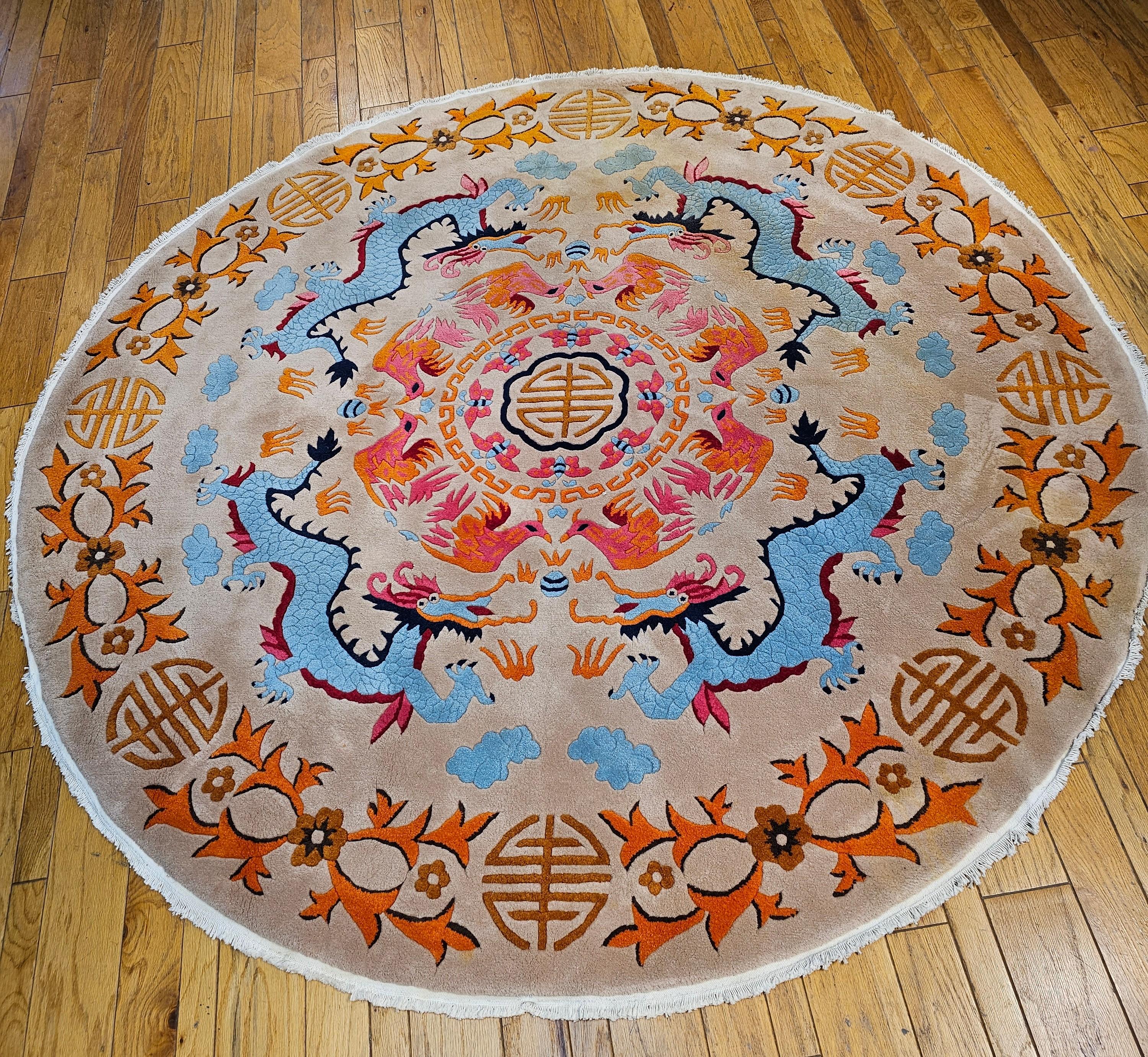 Extremely rare round Chinese Art Deco room size rug in beautiful vibrant colors circa the mid 1900s.  The rug has a fantastic design of four dragons in robin's egg blue with a symbol of fortune in the center surrendered by rooster designs in