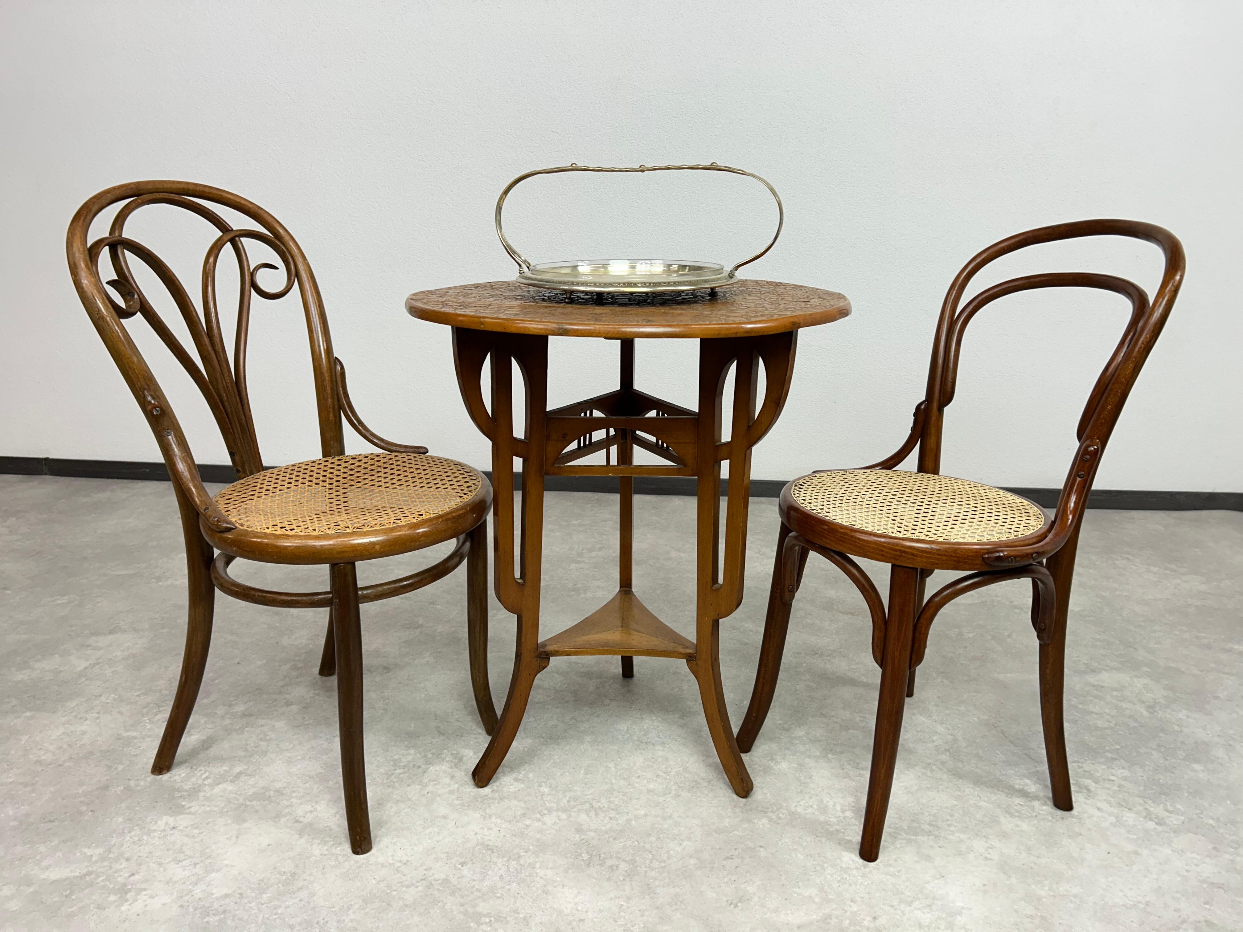 Round art nouveau table with carved top in nice original vintage condition.