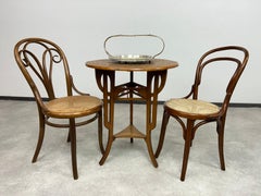 Round art nouveau coffee table with carved top