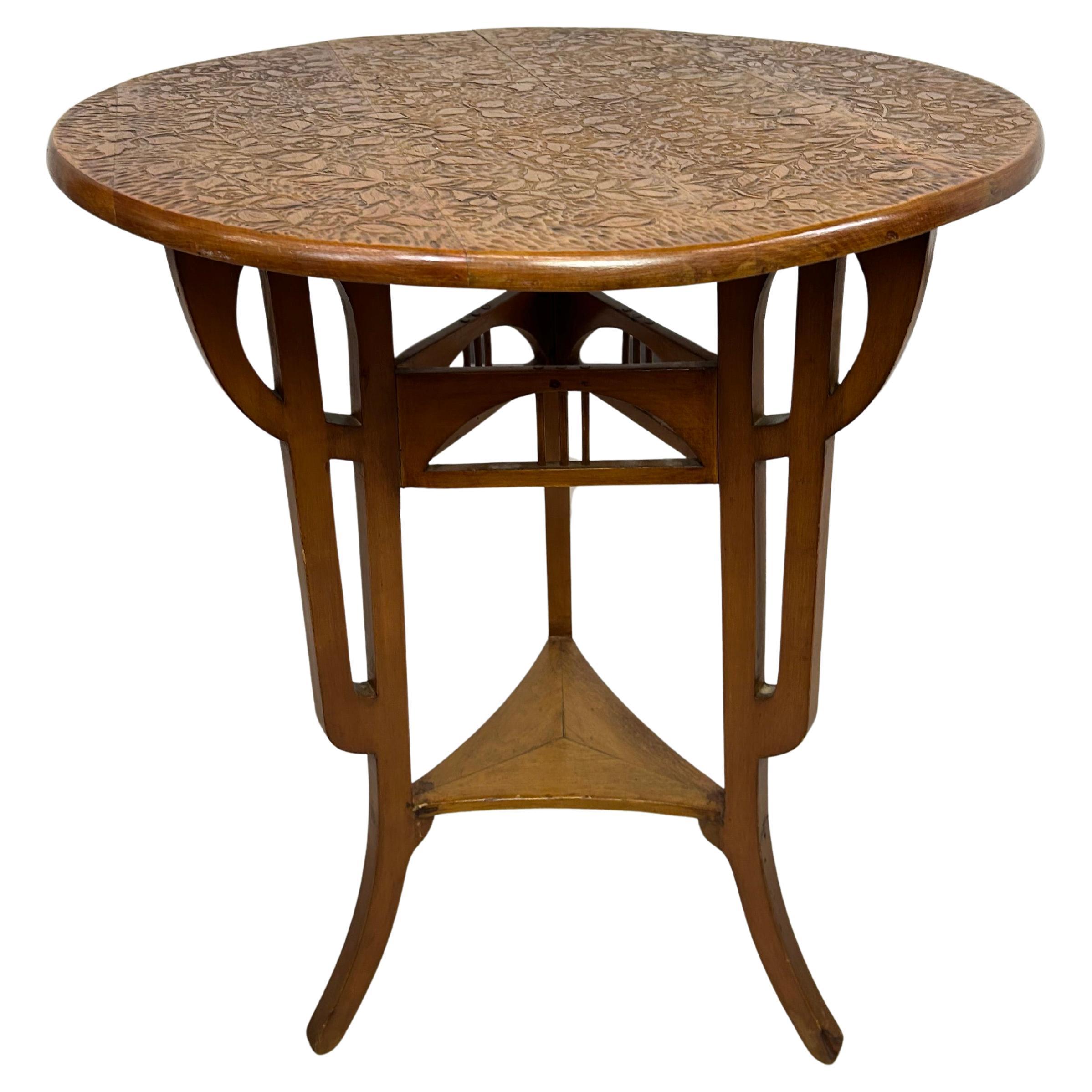 Round art nouveau coffee table with carved top For Sale