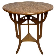 Round art nouveau coffee table with carved top