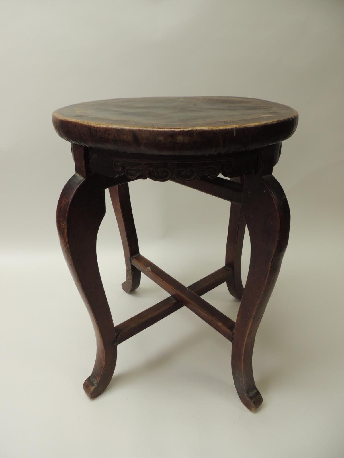 Round Asian side table or stool with carved apron and turned wood legs.
Pig skin covered round side table or sturdy enough to use as a stool.
X base crossed legs.
Size: 15