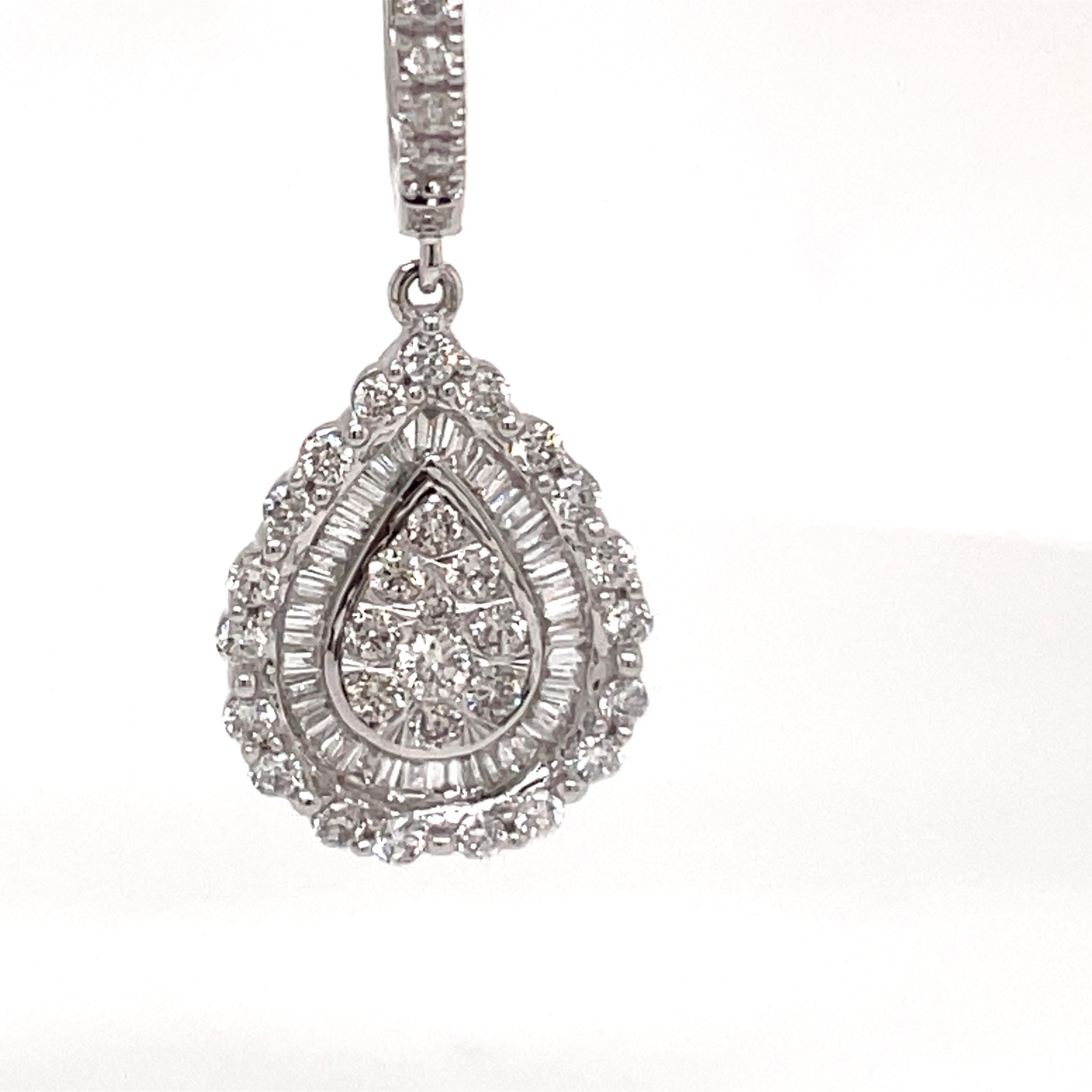 14 Karat White gold drop featuring a cluster of round and baguette diamonds weighing 1 carat.
Color G-H
Clarity SI