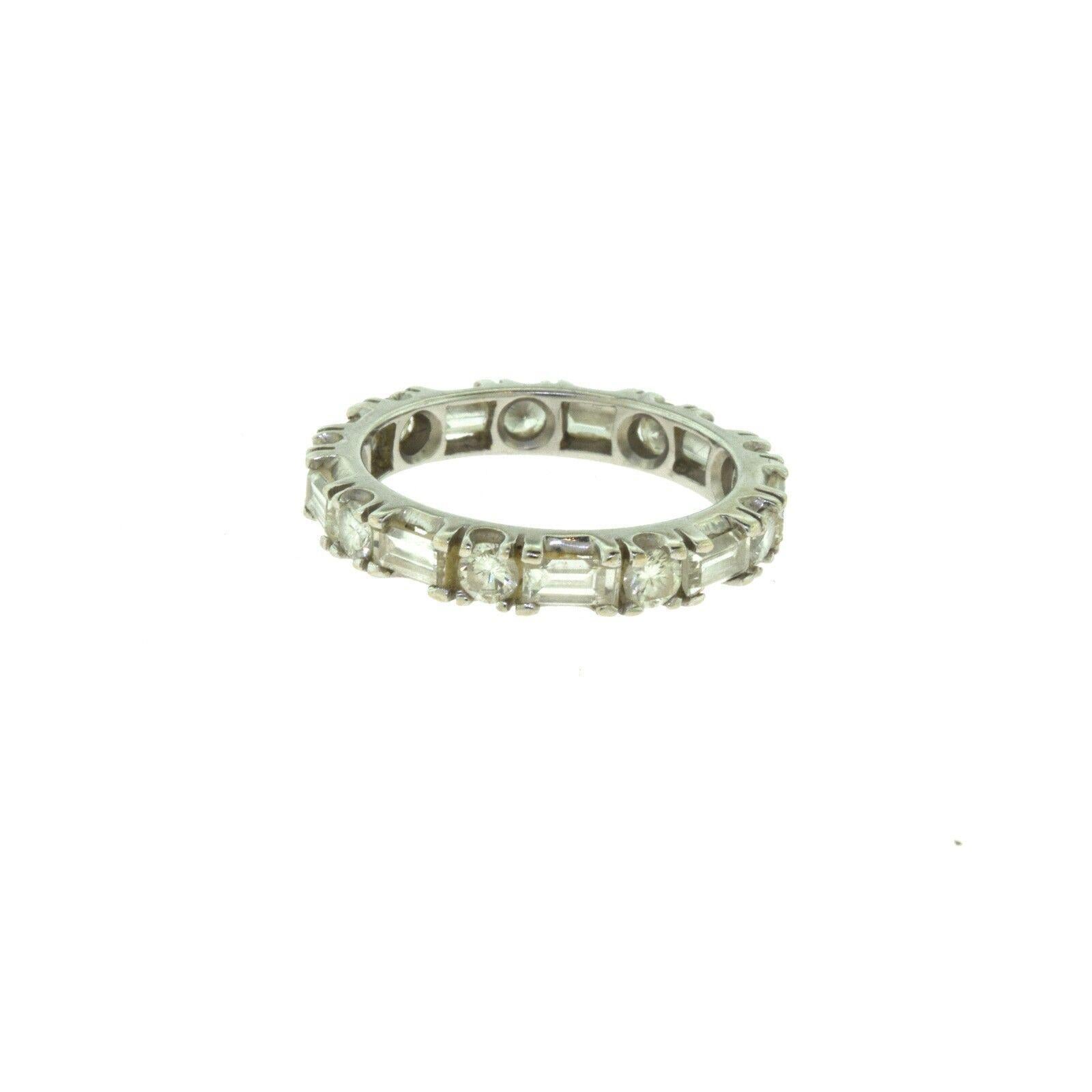 Title: Round and Baguette Diamond Full Eternity Wedding White Gold Band

ITEM SPECIFICATIONS:

- Style: Diamond Eternity Wedding Band
- Metal: White Gold
- Metal Purity: 14k
- Stones: 9 Round Diamonds​​​​​​​ ; 9 Baguette Diamonds
- Diamond Color:
