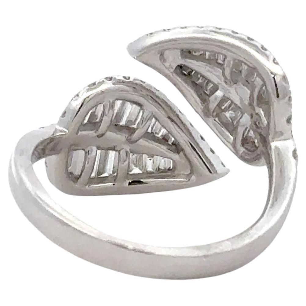 18 Karat white gold ring featuring two diamond leaves containing 32 baguettes weighing 0.69 carats and 70 round brilliants weighing 0.65 carats. 
Size 7