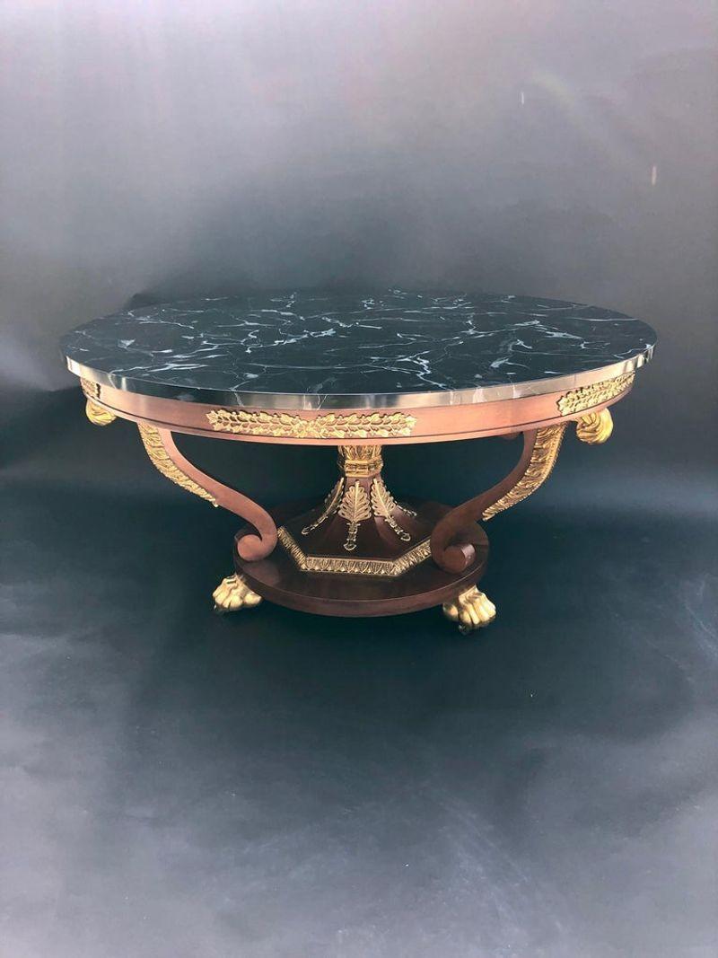 Baker table with black faux marble top. Gilt wood, bronze and mahogany base.