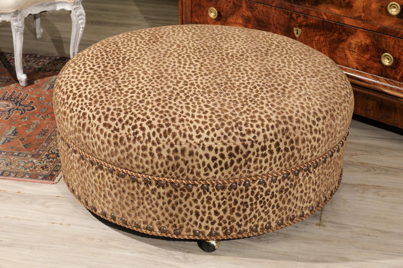 A great size ottoman to be very functional. It is a Baker piece which has recently been reupholstered in a Lee Jofa animal print fabric.
Braid and nail heads add the perfect detailing. It stands on casters.