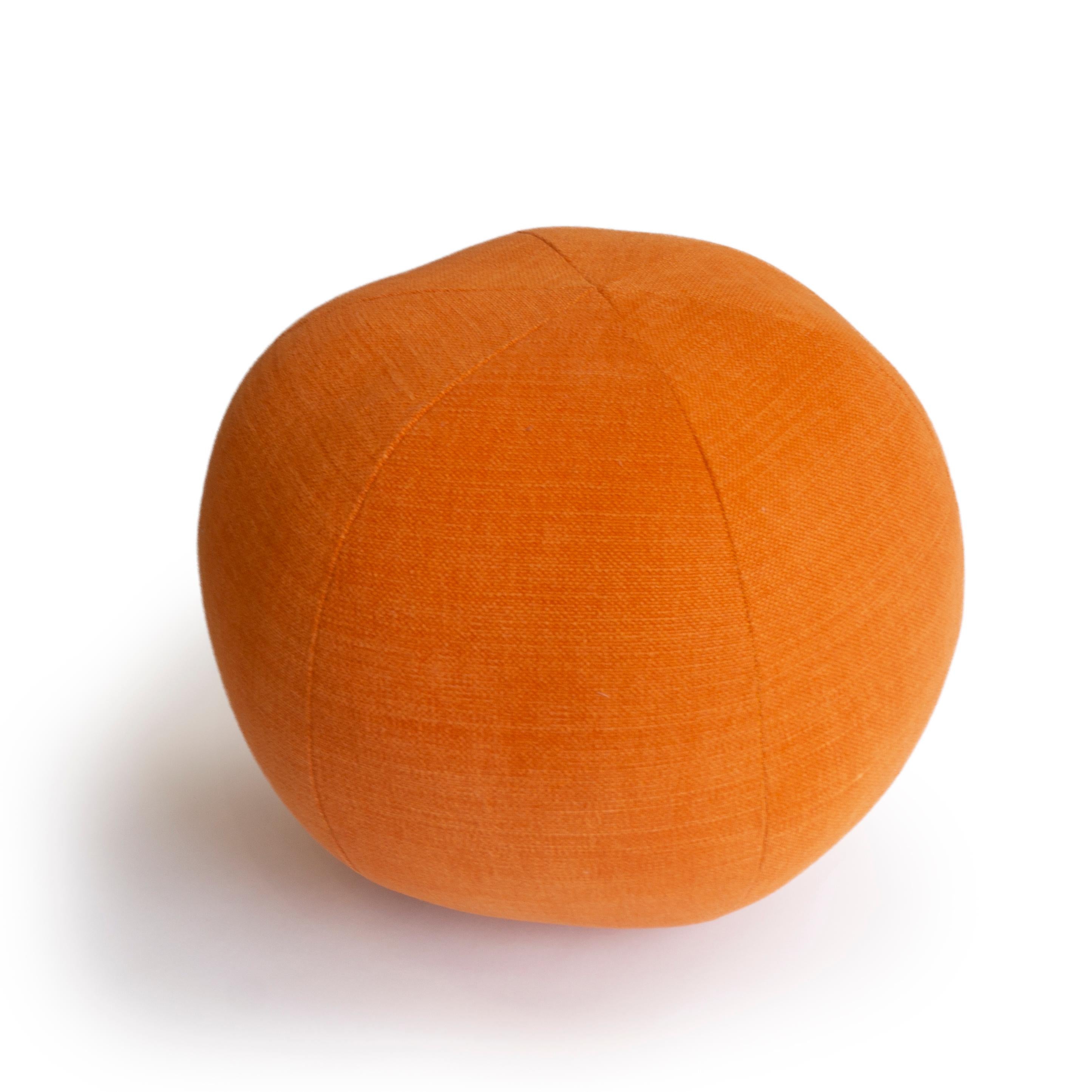 A hand sewn round ball pillow in orange fabric. All pillows are made at our studio in Norwalk, Connecticut. 

Measurements: 9