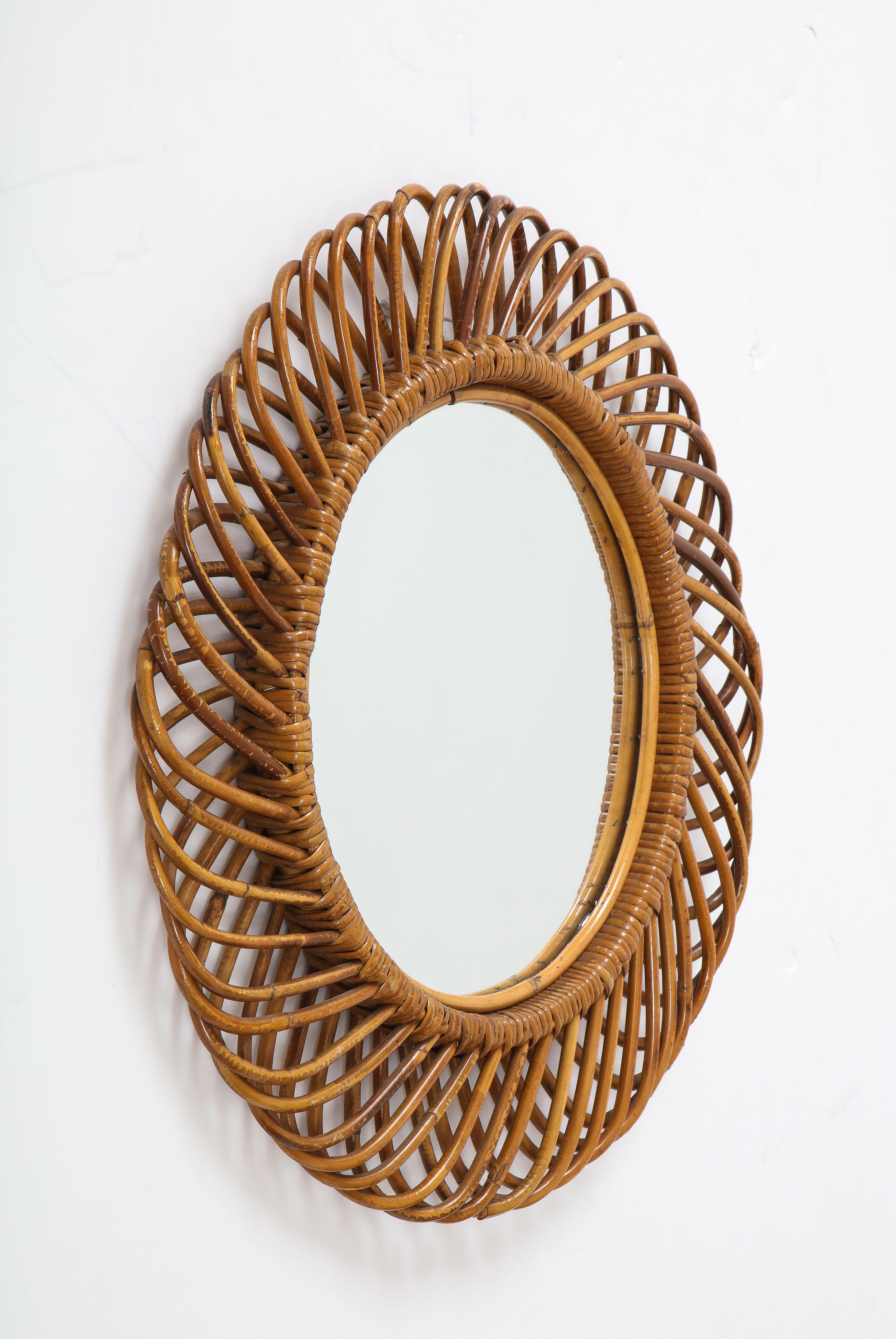 A classic interlocking bamboo Italian 1950's circular mirror by Bonacina; with original velvet backing. 
Italy, circa 1950 
Size: 25 1/2' diameter x 1 1/2