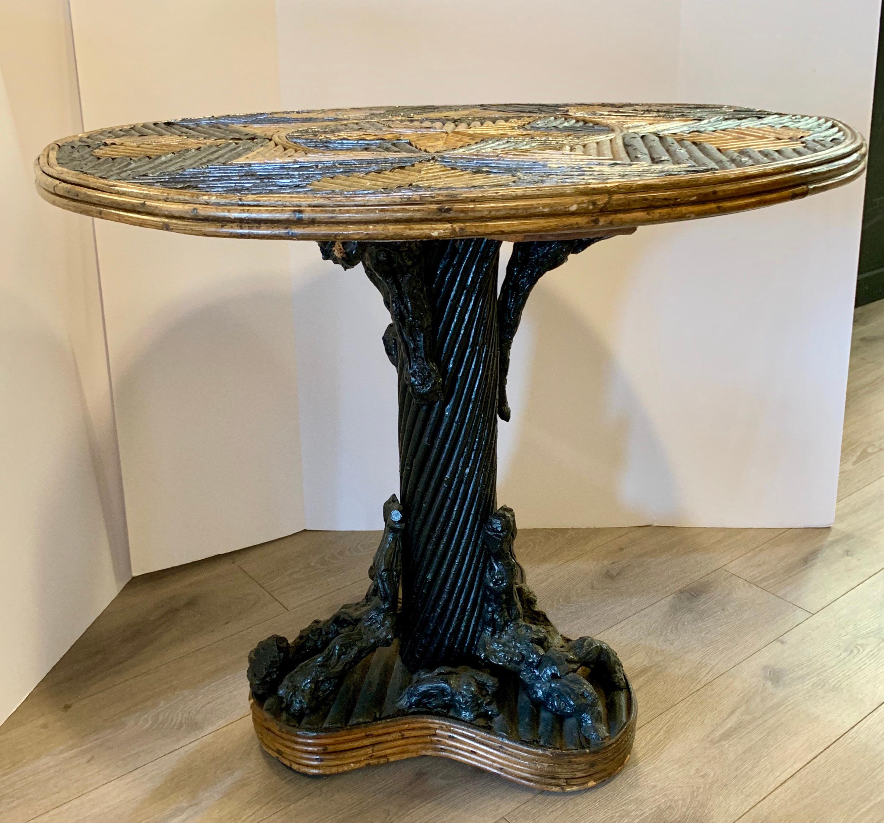 Geometric bent twig detailing on the top and pedestal base give cabin charm to this Adirondack style round table. Features a center star inlay surrounded by hearts inlay. Base has tree root supports.