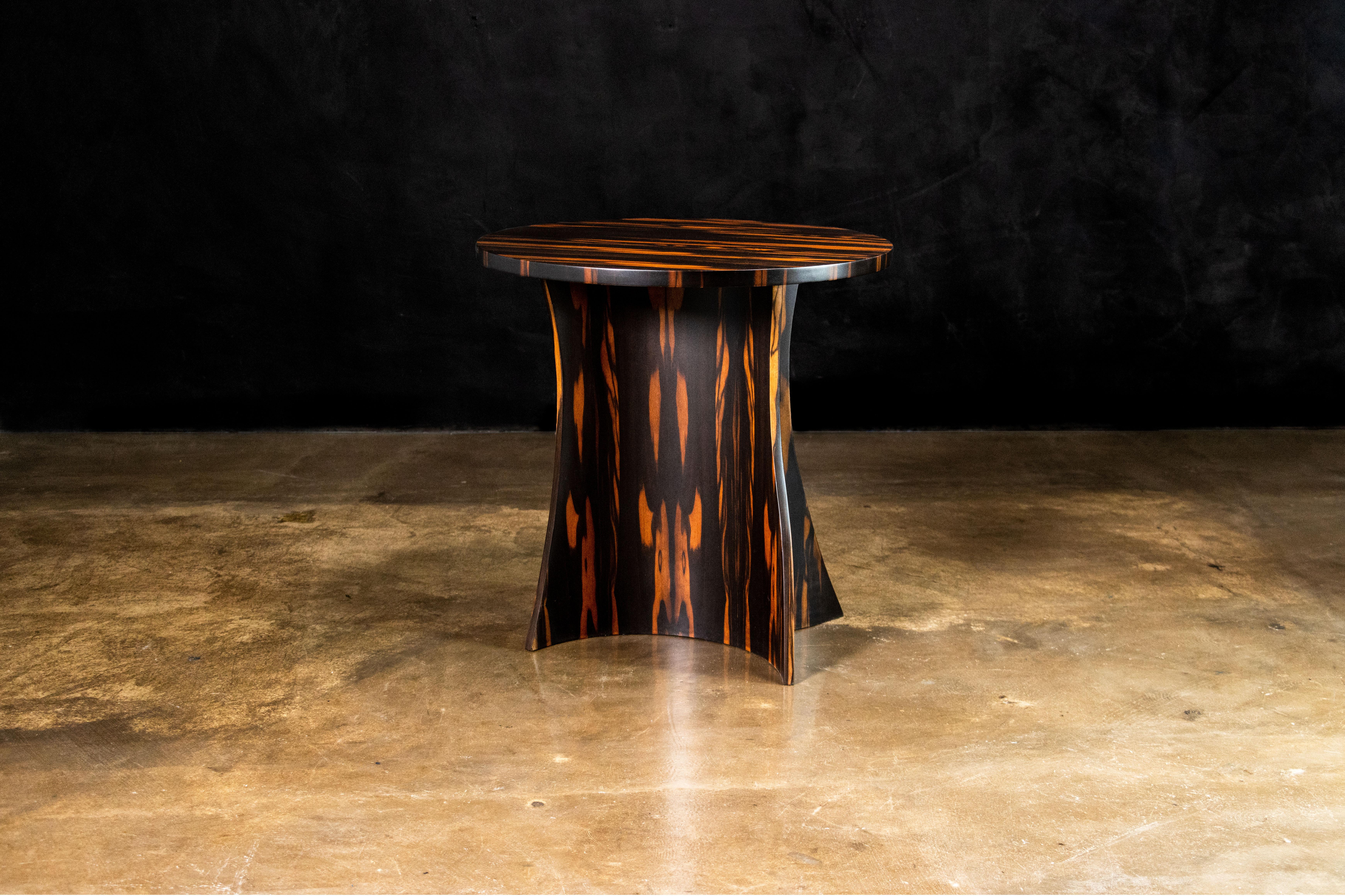 In Stock and available for immediate delivery

The Andino Table features a two-part curved wood base whose shape is seemingly unique from every angle. Shown here in Macassar Ebony, it is customizable in any size or shape top and any