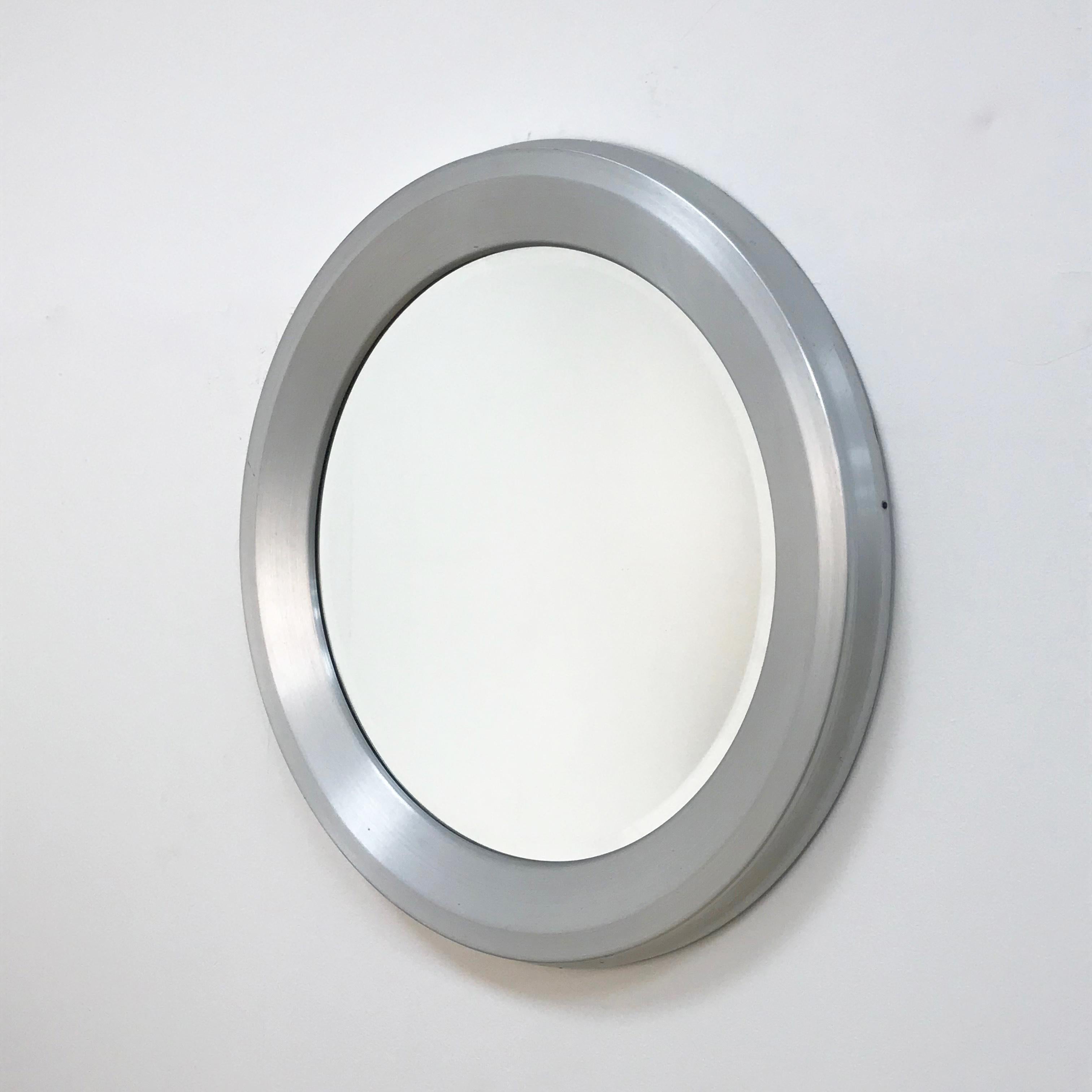 Attributable to Sergio Mazza for Artemide
Italian modernist aluminum mirror.
The original mirror in the centre is in excellent condition and the frame has a concave centre that creates depth and texture. This simple mirror is quite surprising and
