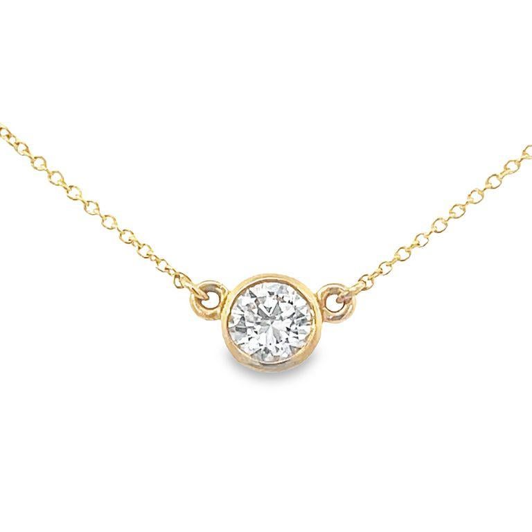 Solitaire round white diamond pendant crafted in a bezel design in a 9 inches long cable necklace 14K yellow gold. This necklace is an elegant accessory that perfectly balances grace and style. Handcrafted with meticulous attention to detail. 