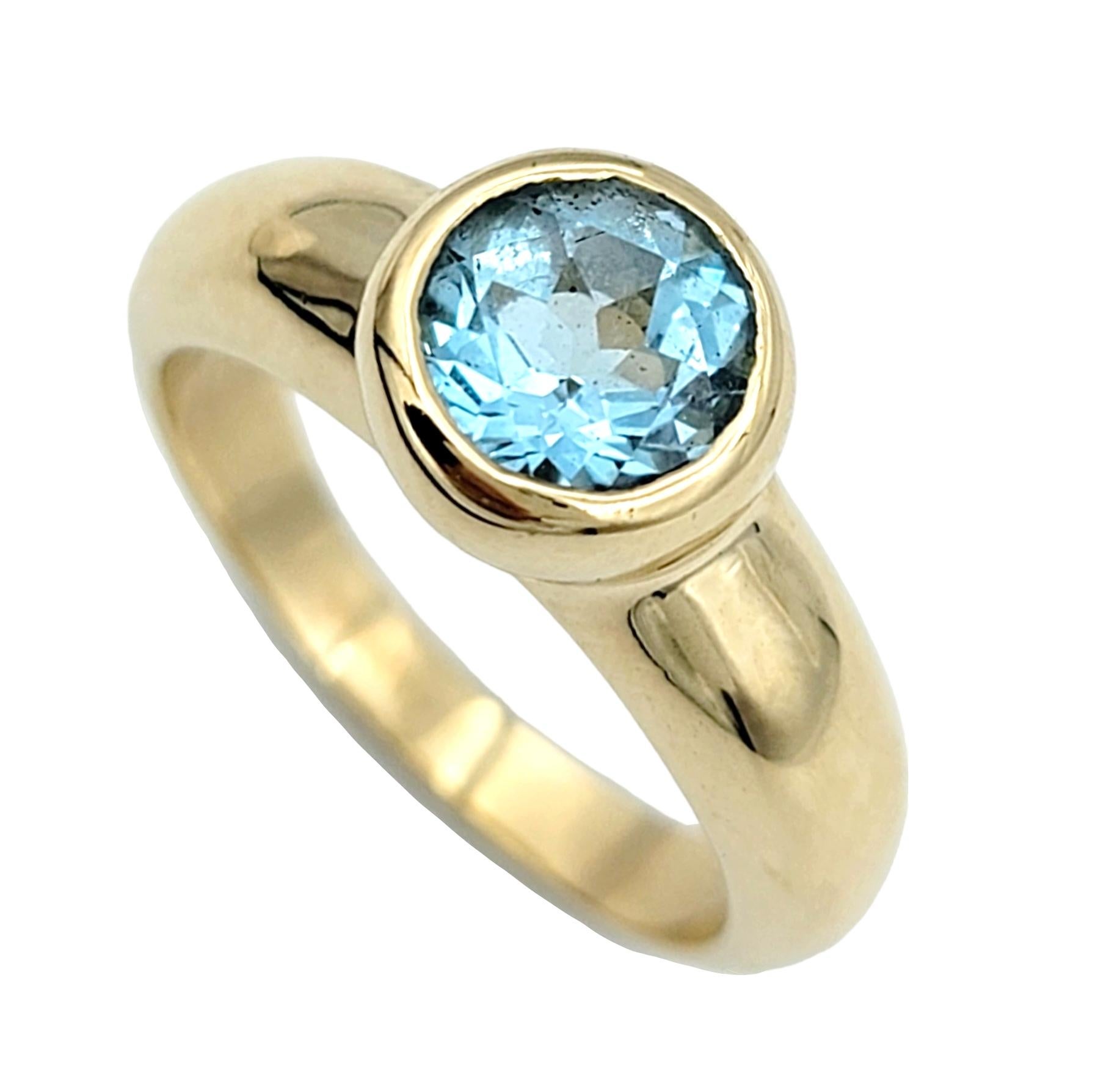 Contemporary Round Bezel Set Blue Topaz Solitaire Band Ring in Polished 14 Karat Yellow Gold For Sale