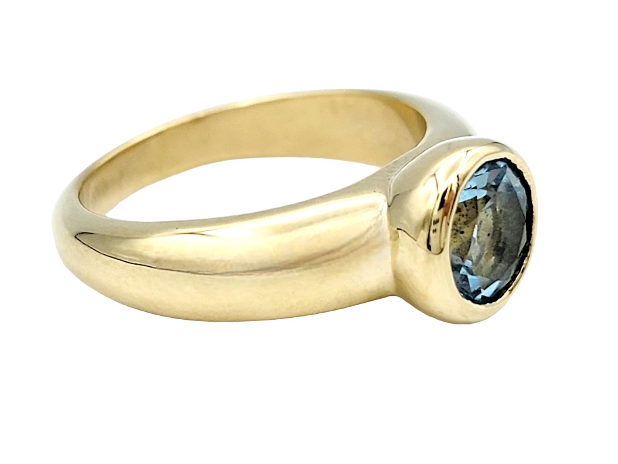 Round Cut Round Bezel Set Blue Topaz Solitaire Band Ring in Polished 14 Karat Yellow Gold For Sale