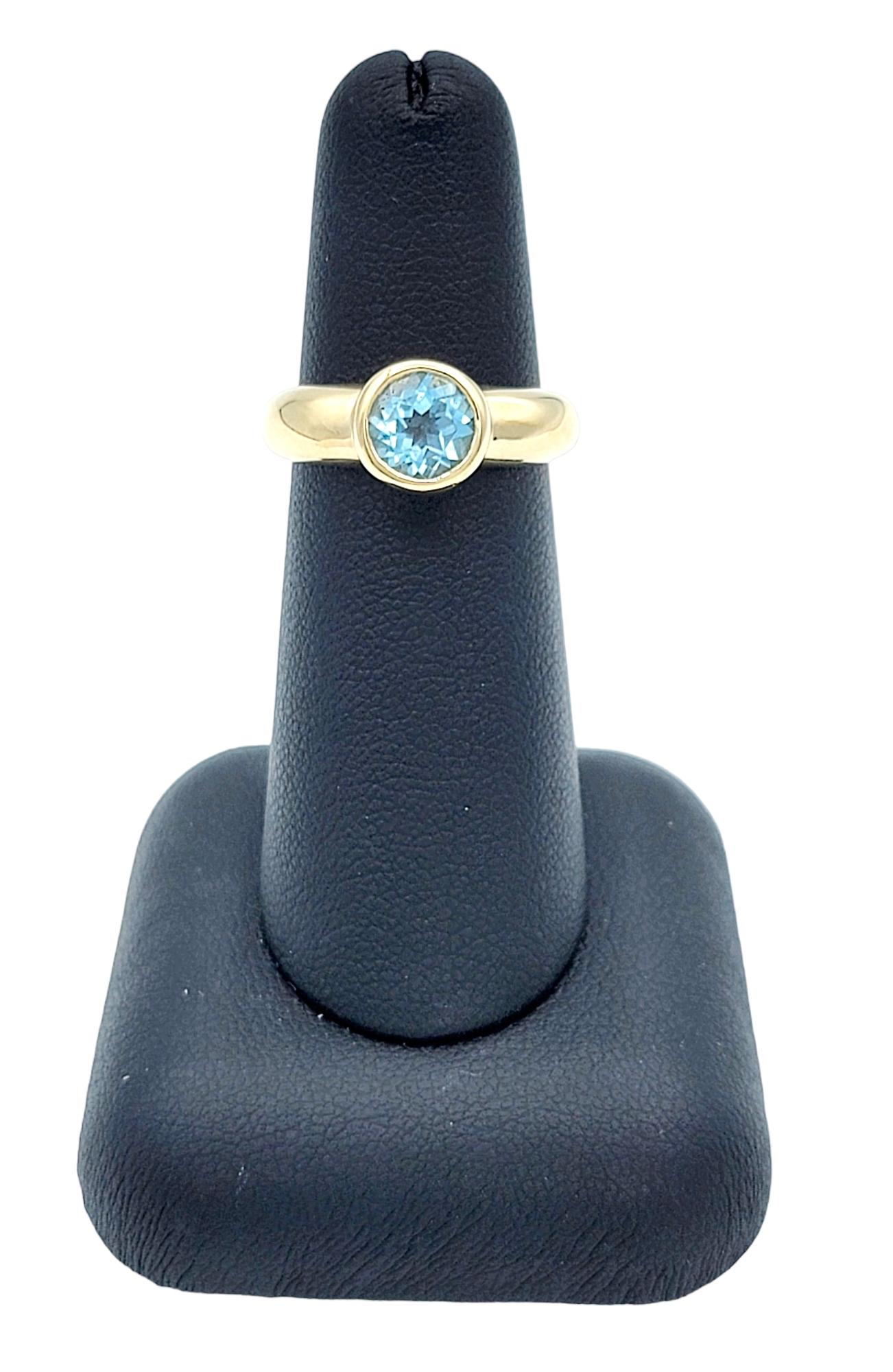 Round Bezel Set Blue Topaz Solitaire Band Ring in Polished 14 Karat Yellow Gold For Sale 2