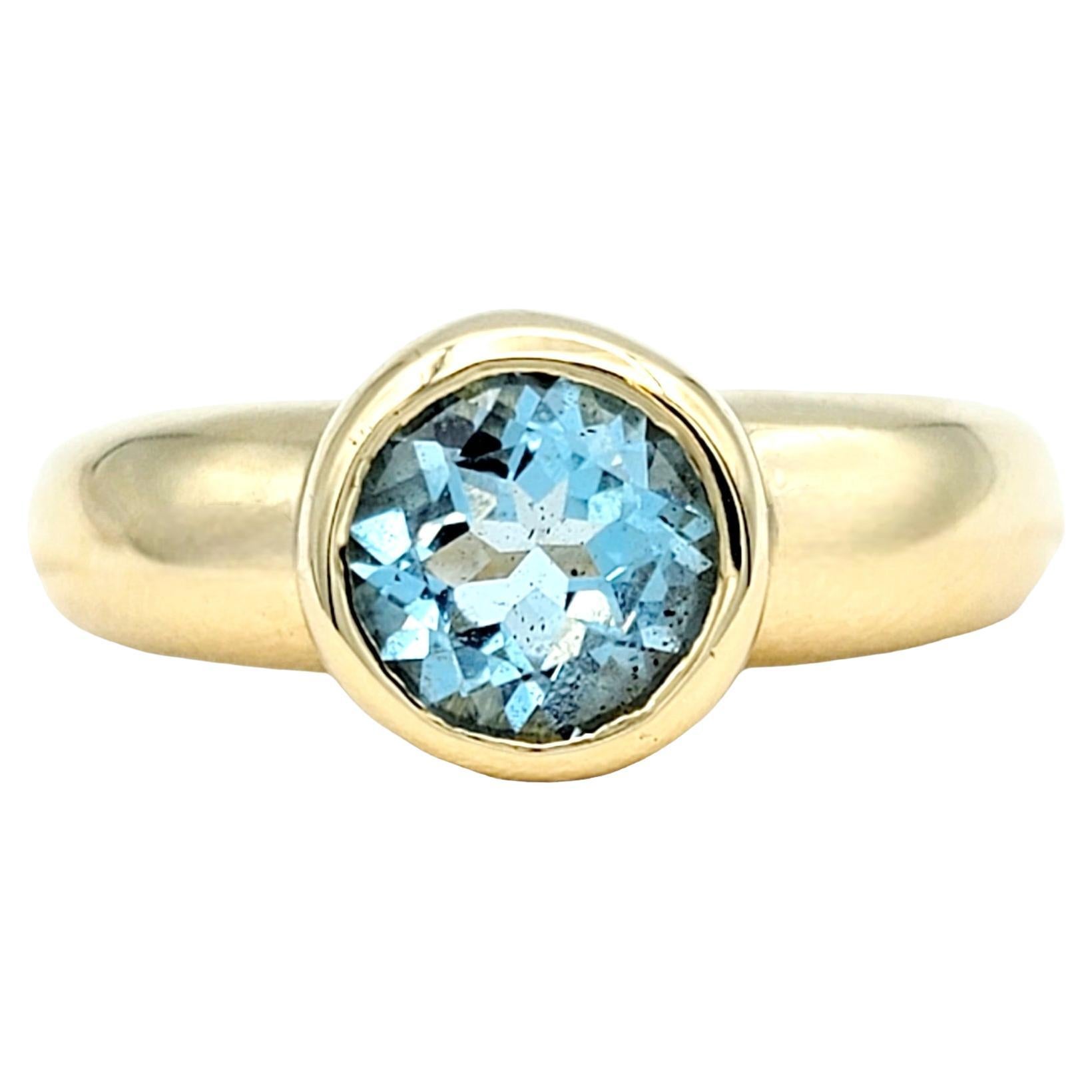 Round Bezel Set Blue Topaz Solitaire Band Ring in Polished 14 Karat Yellow Gold For Sale