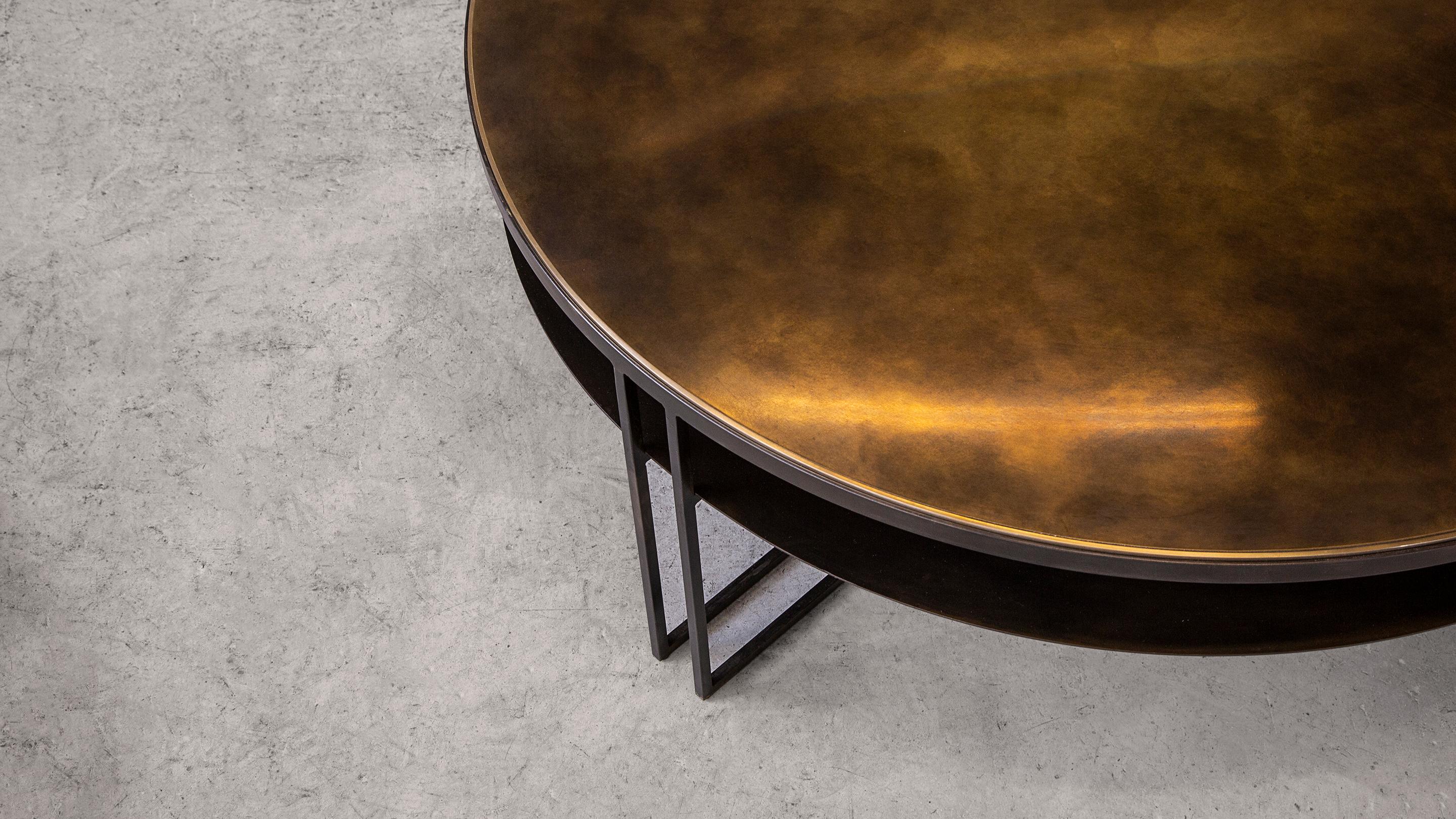 A circular coffee table in patinated brass and blackened steel. Hand crafted to order in the North. Bespoke finishes and sizes are available.

Measures: 120cm dia x 35cm height.
Custom finishes and sizes available upon request.

Made to order