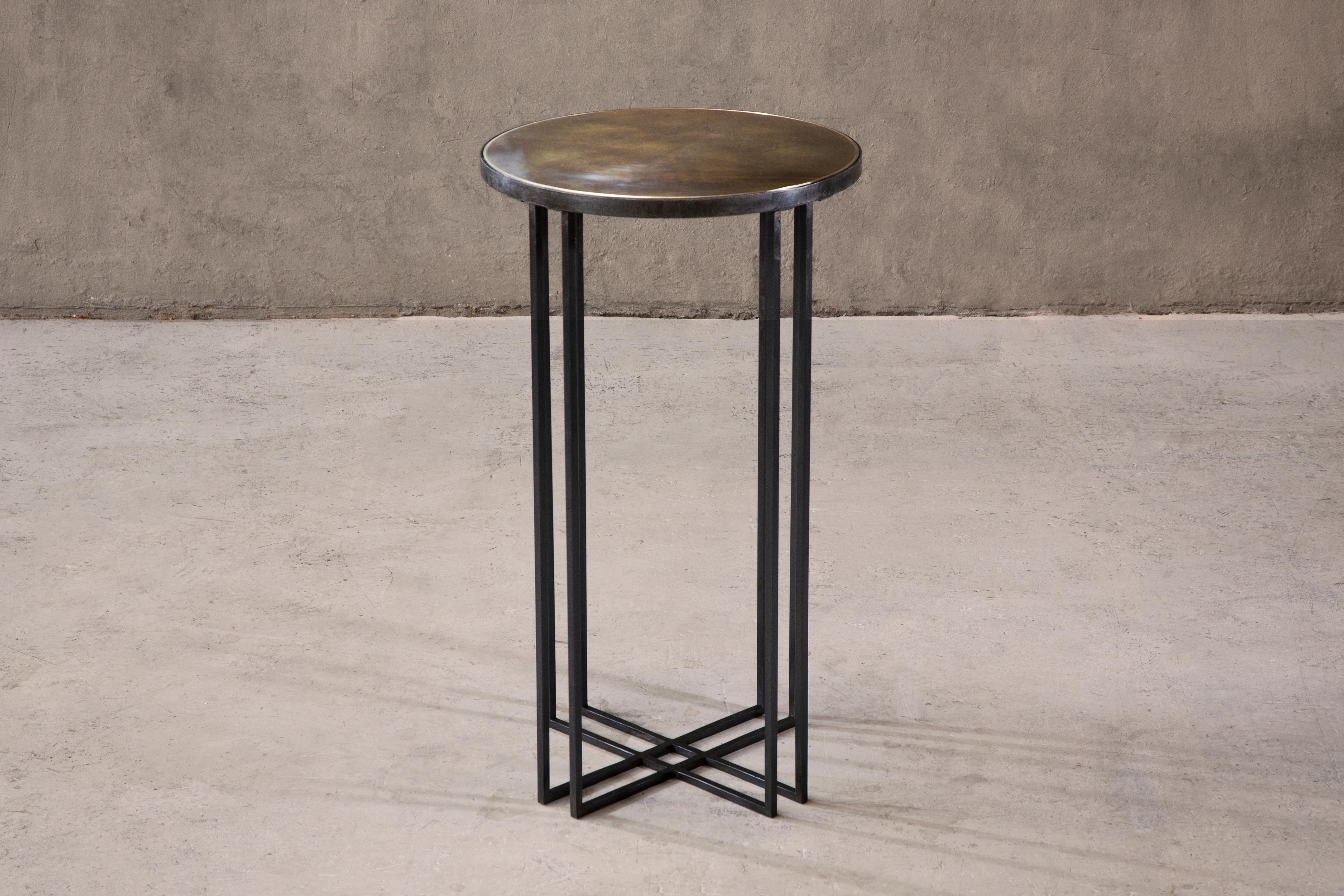 Side table in blackened steel, patinated brass with a brushed brass trim. Handcrafted in North East, England.

Measures: 40cm (diameter) x 90cm (height). 
Custom sizes available.

Made to order in 12 weeks.
Price excludes VAT.