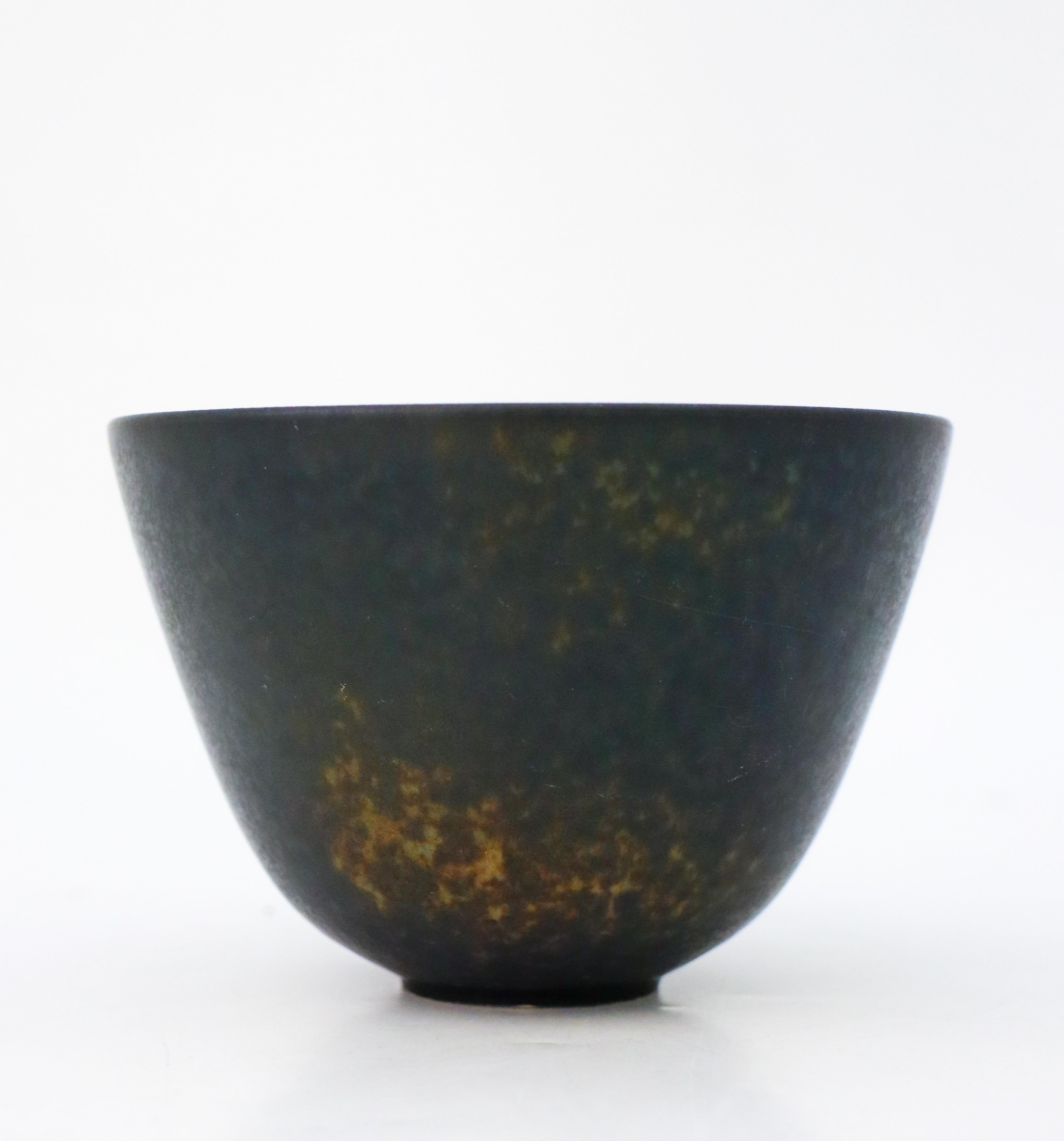 A black bowl designed by Gunnar Nylund at Rörstrand, the bowl is 9 cm (3.6