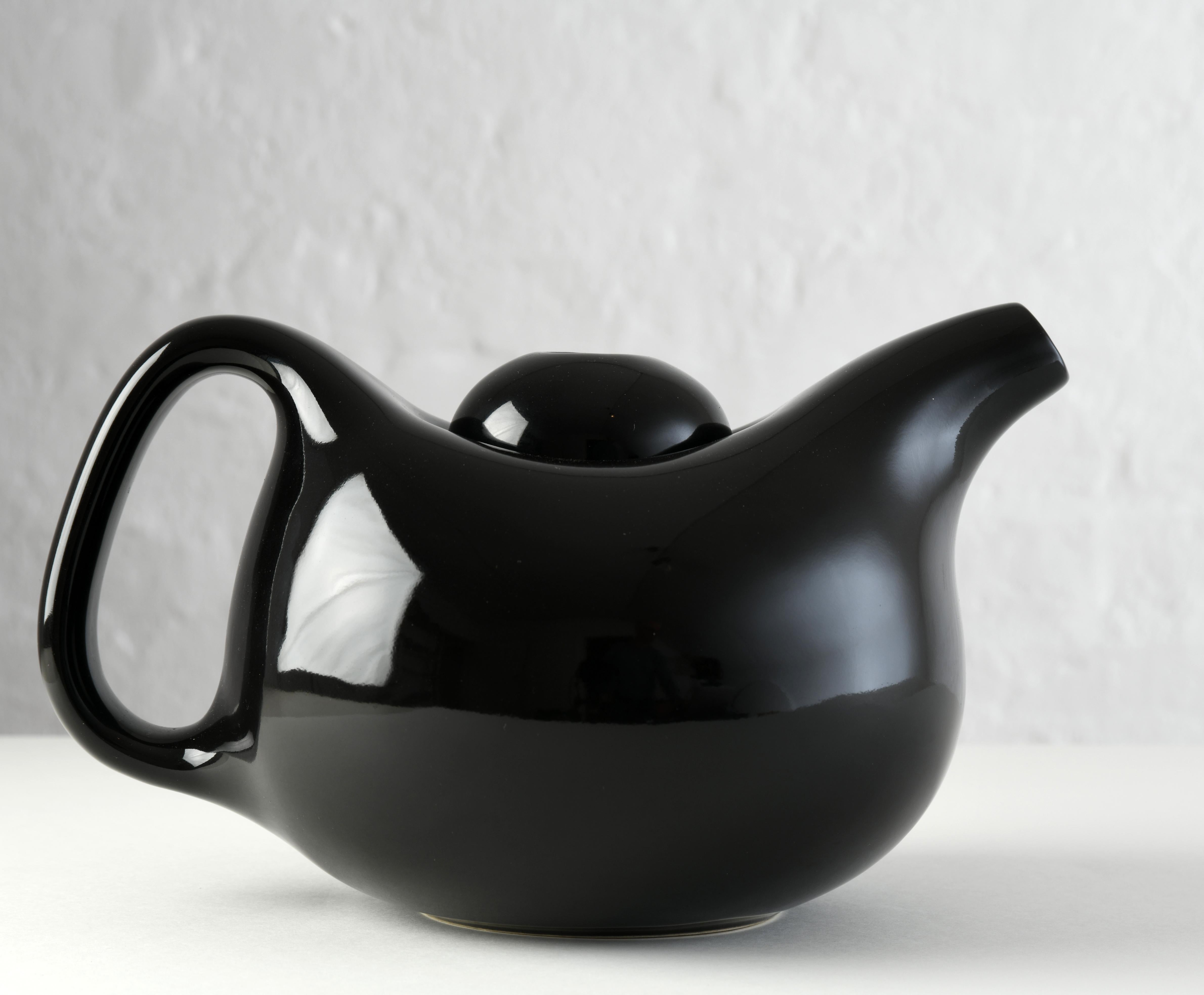 Round black ceramic teapot, produced by Kähler in Denmark in the early 2000s. Designed by Jeanette List Amstrup for the Mano collection. The range is produced by Danish ceramics company Kähler, which has been creating ceramics since 1839. The Mano