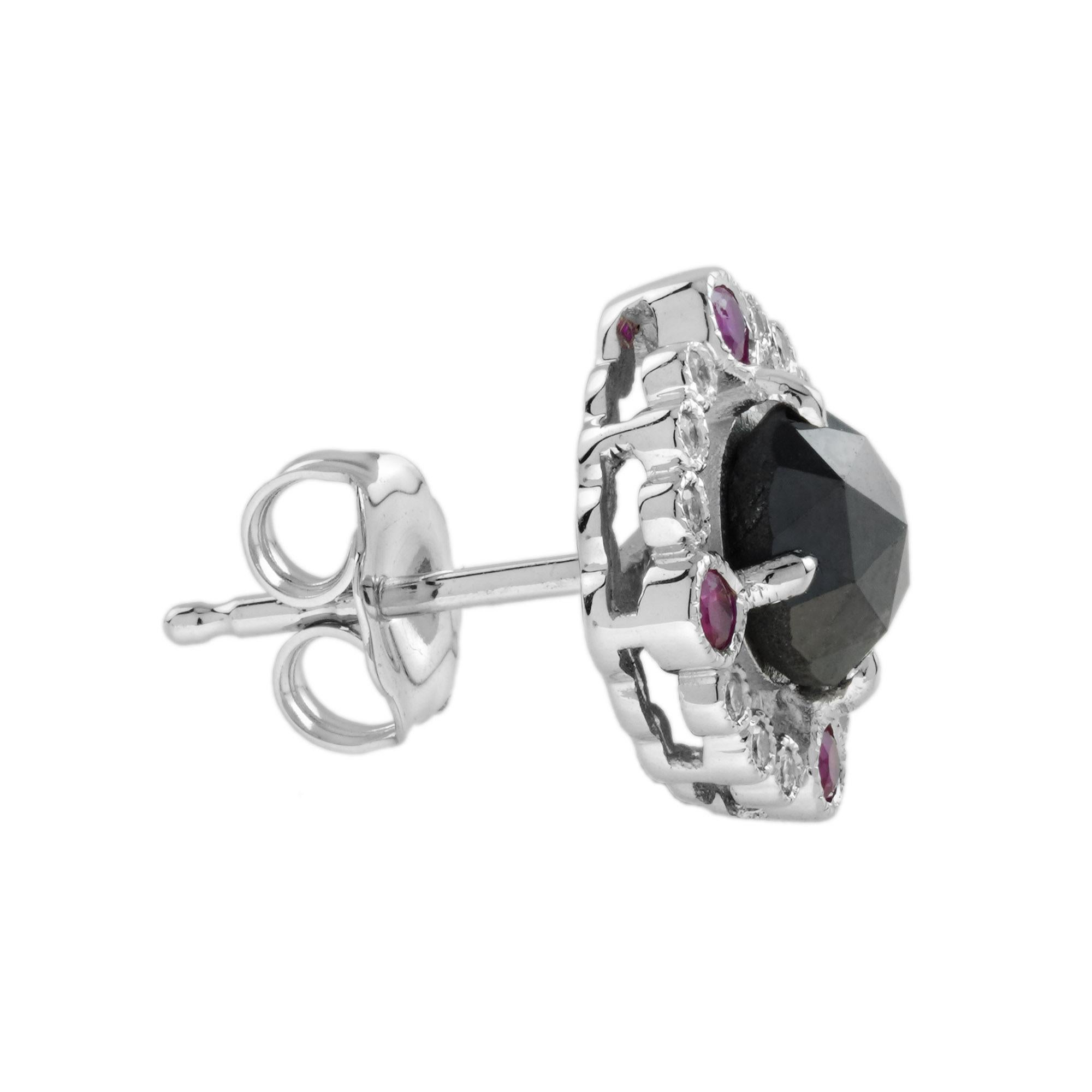Black diamonds are surrounded by glittering halos of twelve white diamonds and four rubies on each piece. Glamorous and elegant, these stud are perfect to wear day and night. 
Earrings Information
Style: Art-deco
Metal: 14K White Gold
Width: 12