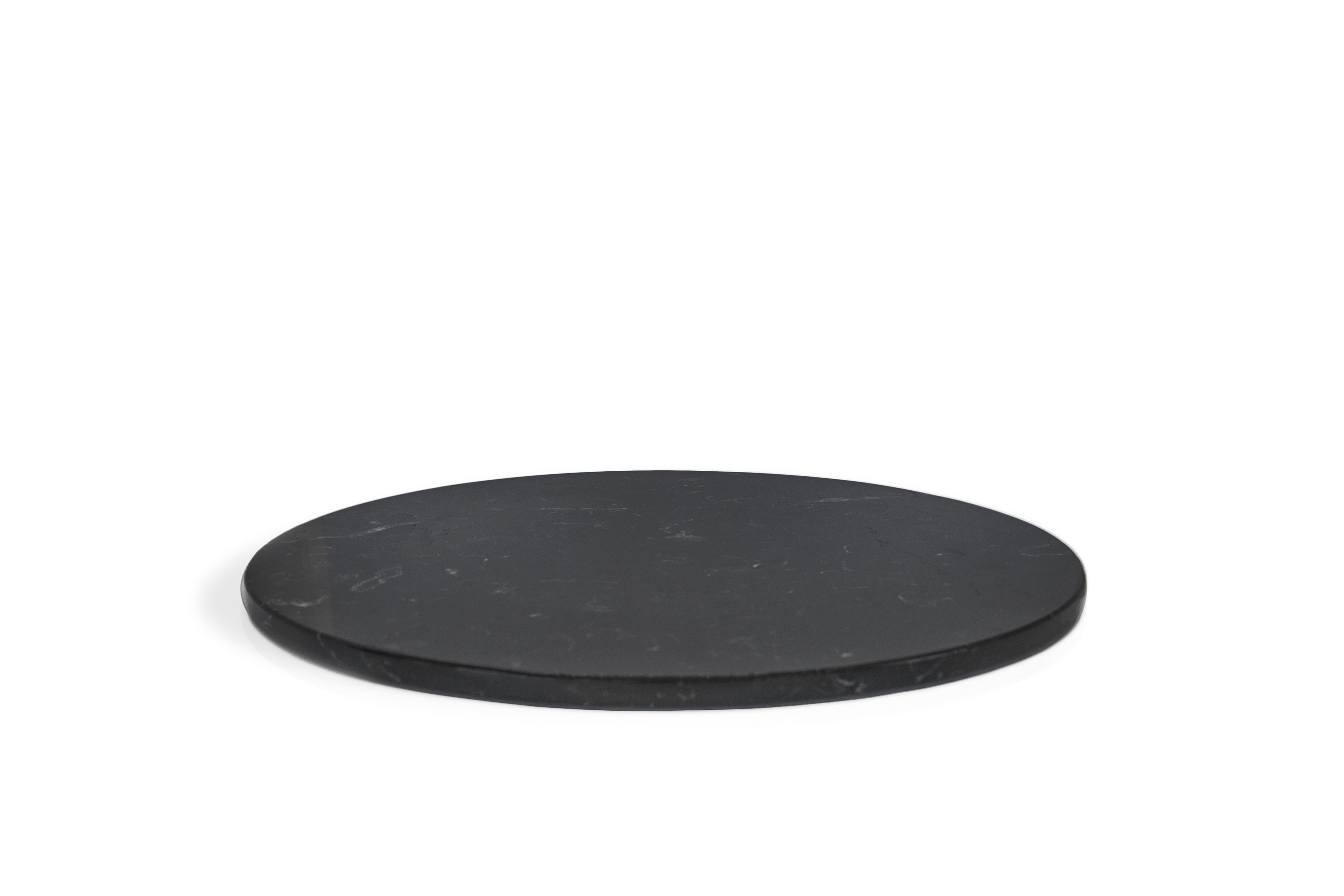 Rounded black Marquina marble cheese plate. Each piece is in a way unique (every marble block is different in veins and shades) and handmade by Italian artisans specialized over generations in processing marble. Slight variations in shape, color and